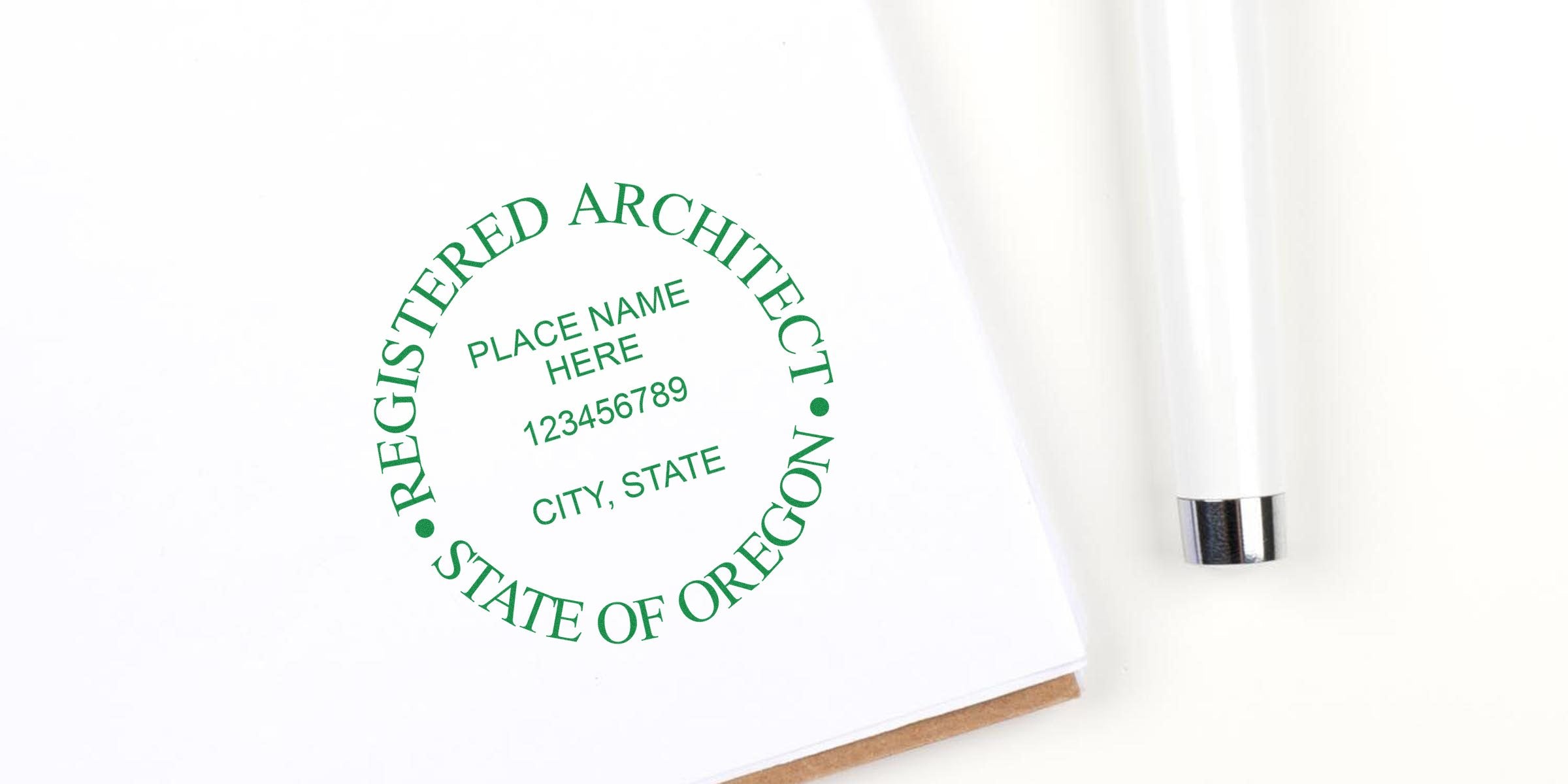 Affordable custom Oregon architect seals with registered architect stamps and pen on white paper for certification.