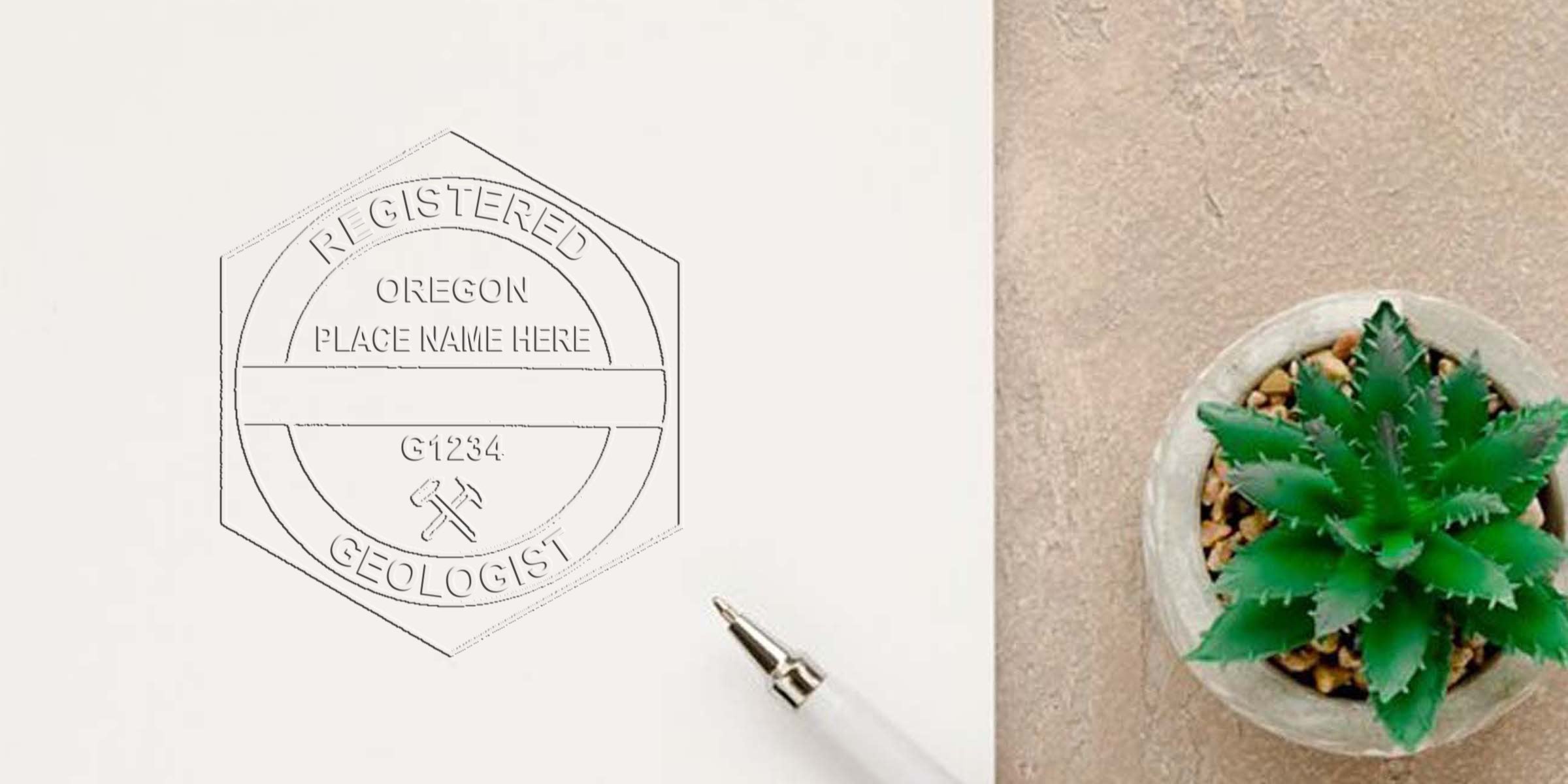 Official Oregon Geologist Seal stamped on paper with a pen and green succulent on a beige surface.