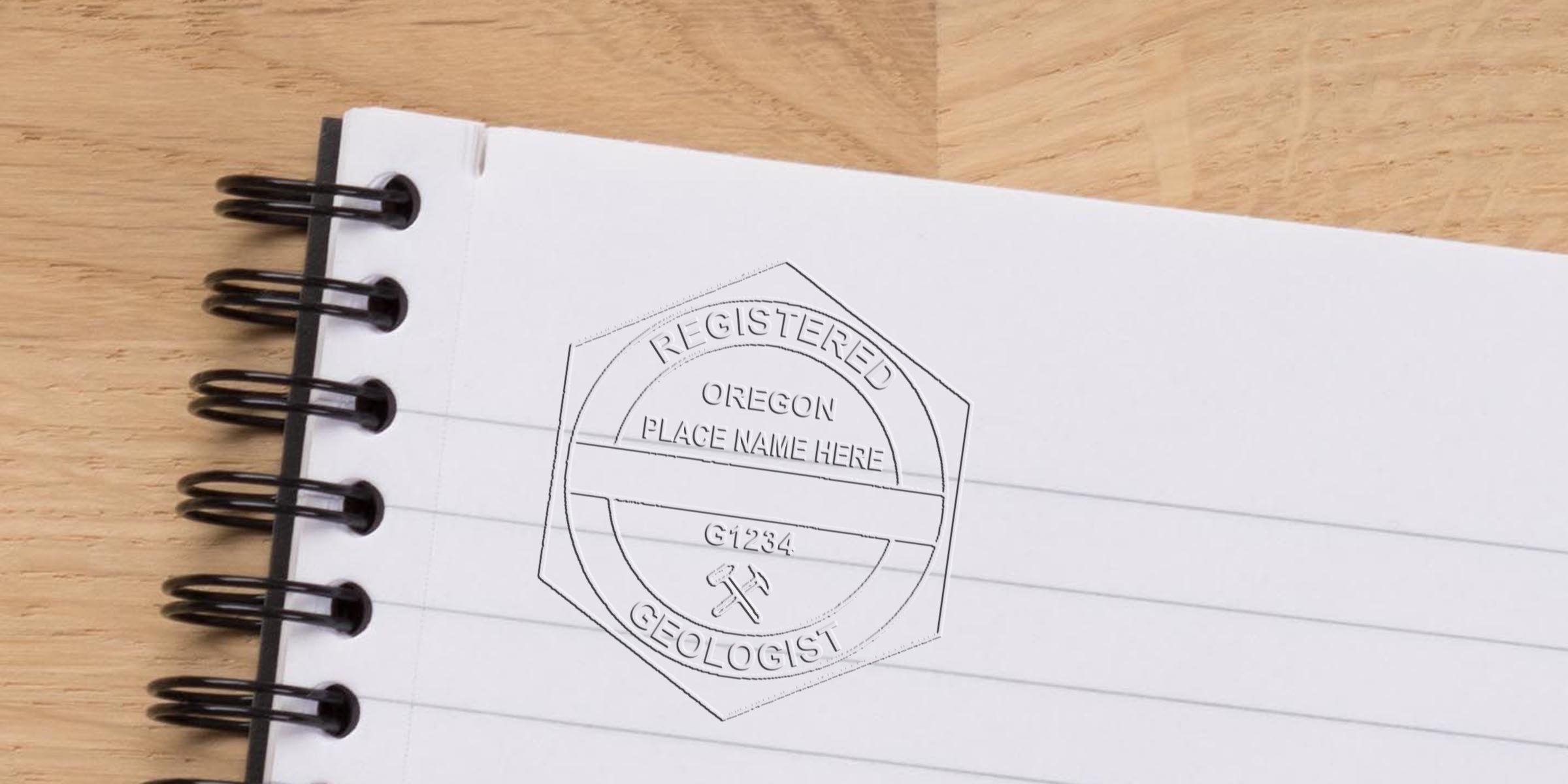 Embossed stamp of a registered Oregon geologist on a notebook page, showing Oregon geologist license requirements and stamp rules.