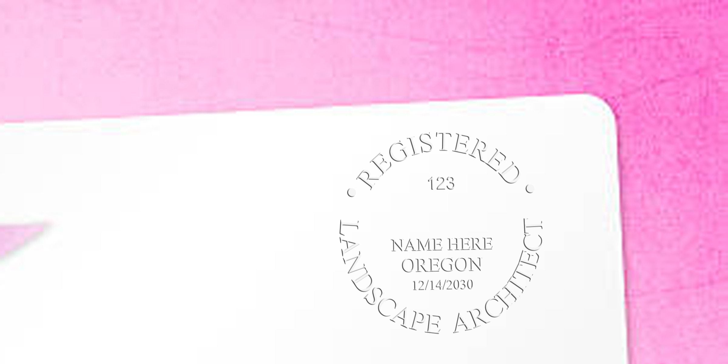 Oregon landscape architect stamp on white paper with pink background, symbolizing Oregon landscape architect licensing.