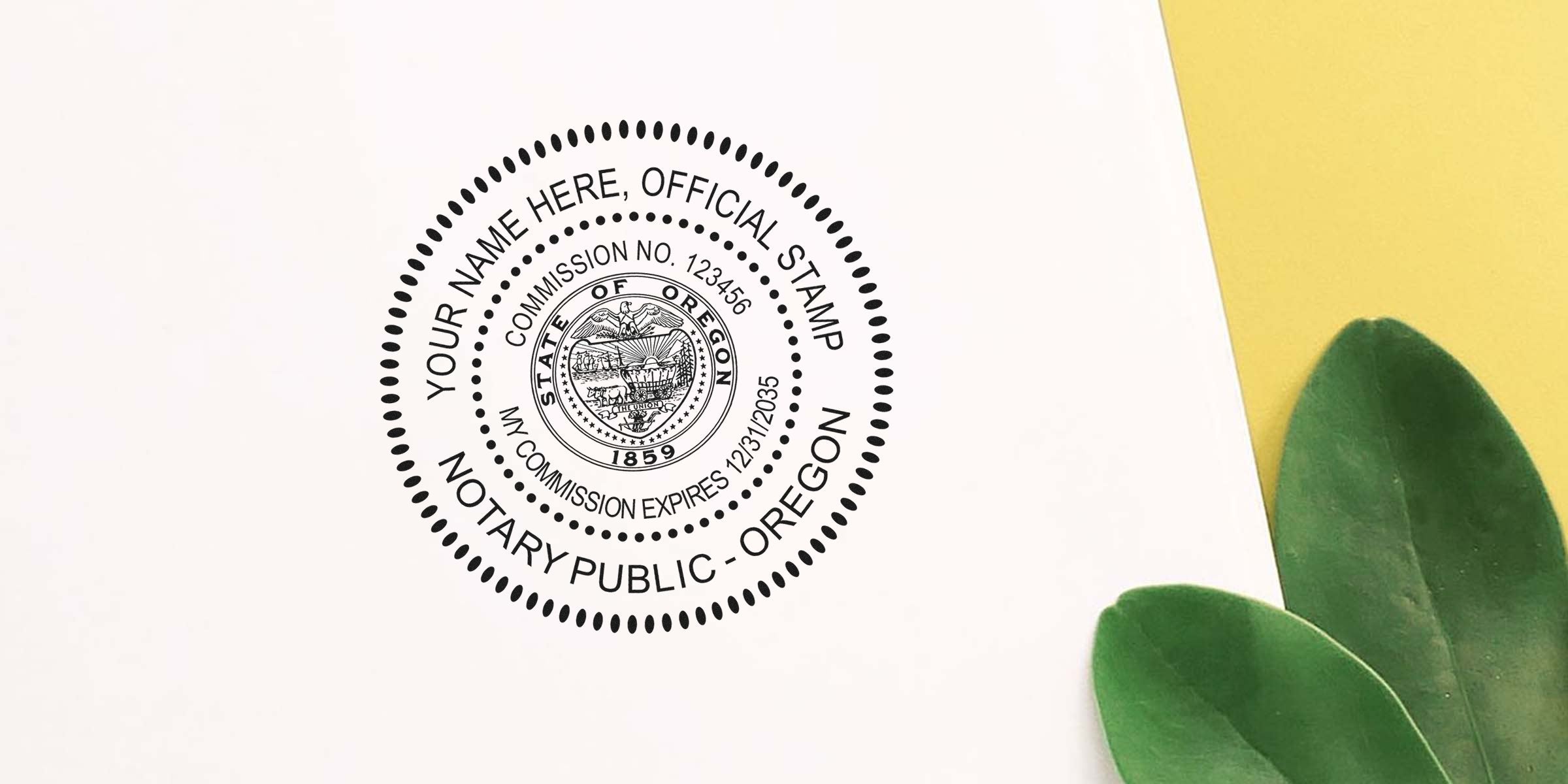 Oregon notary public stamp with commission number and expiration date on white paper, next to green leaves, part of Oregon notary supplies and upgraded notary public kit.