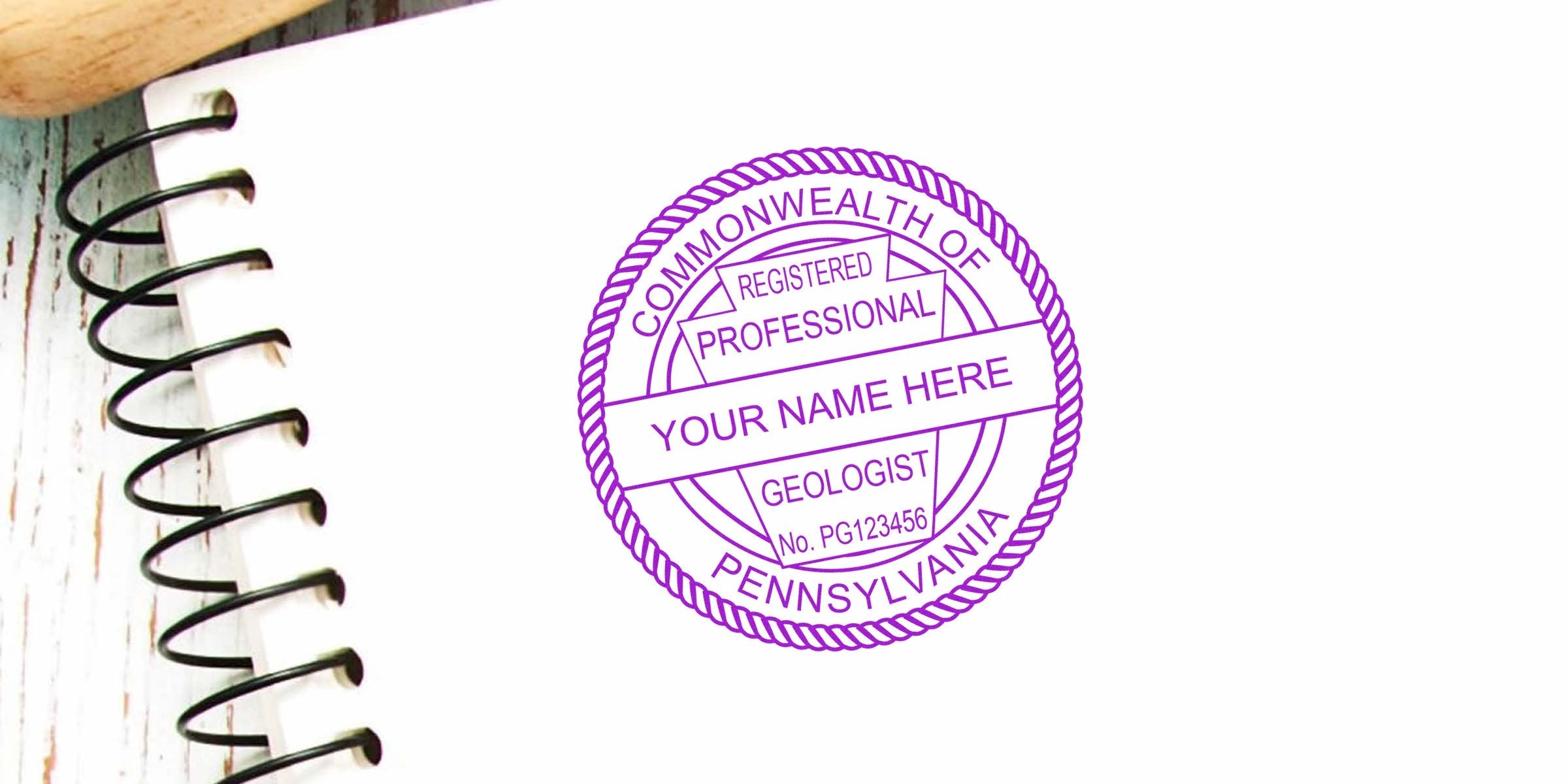 Professional Pennsylvania geologist stamp on notebook with wooden background, showing size specifications.