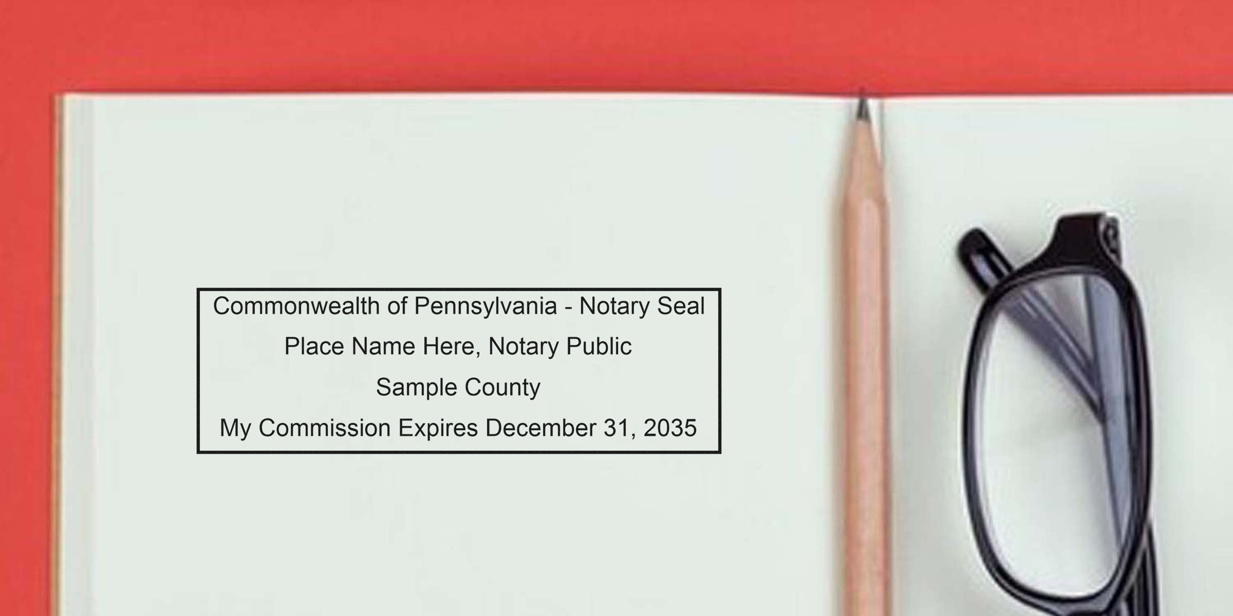 Pennsylvania notary seal on open notebook with pencil and glasses, showing commission expiration details, featured in a notary stamp buying guide.