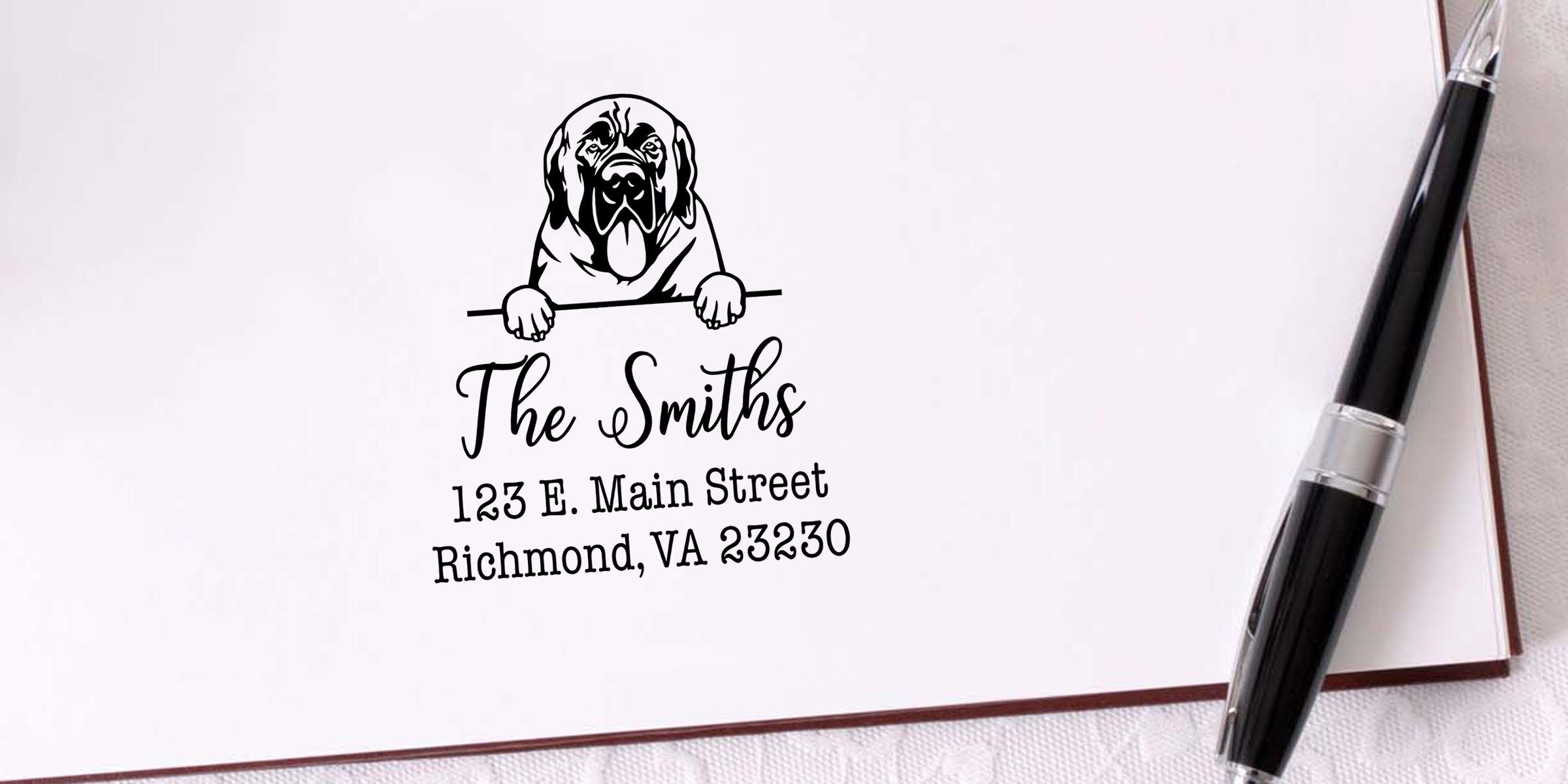Personalized dog-themed stationery with “The Smiths” and Richmond, VA address, featuring a black-and-white dog logo and pen on paper