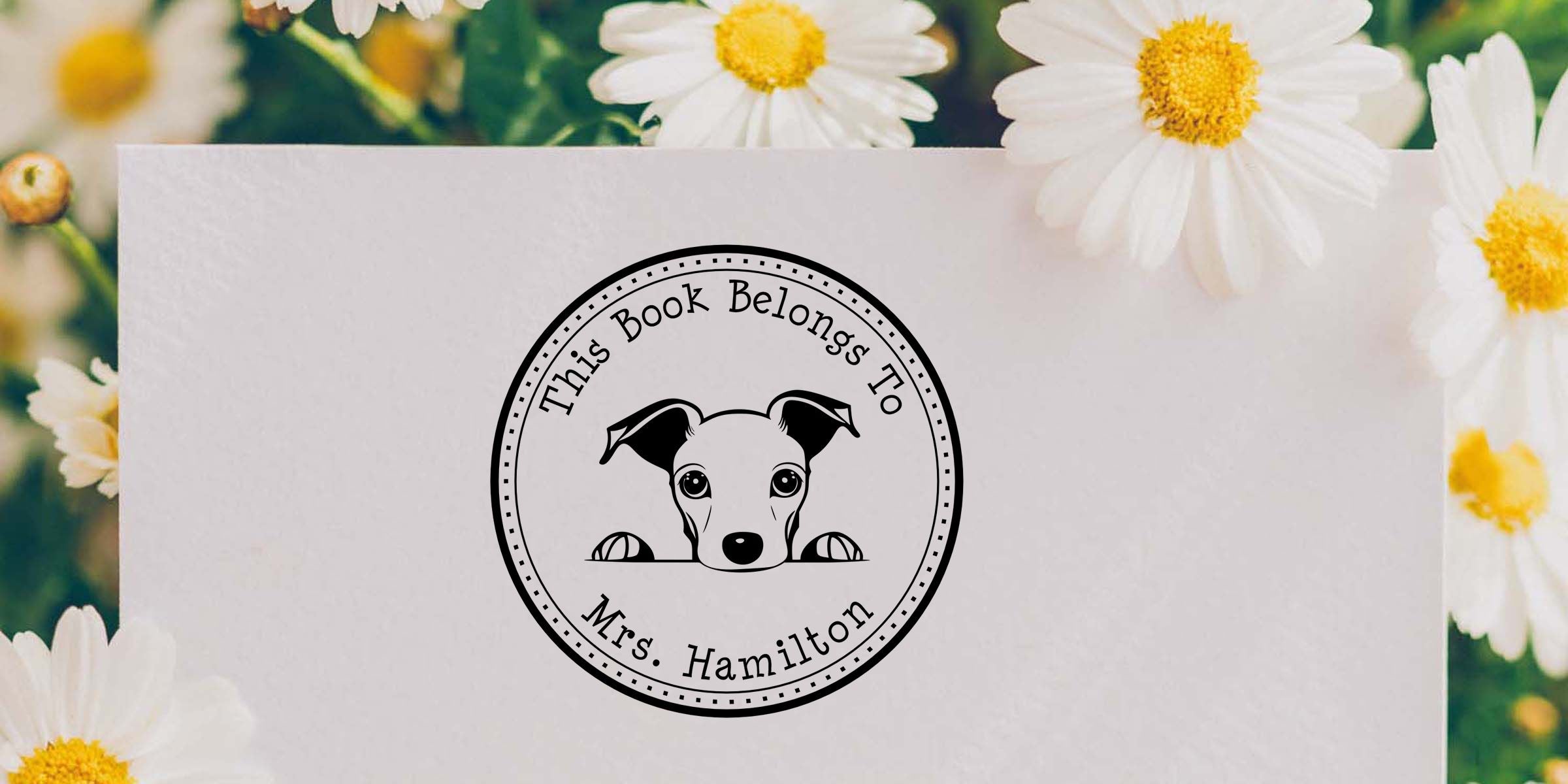 Personalized “This Book Belongs to Mrs. Hamilton” book stamp with puppy illustration on a white card surrounded by daisies