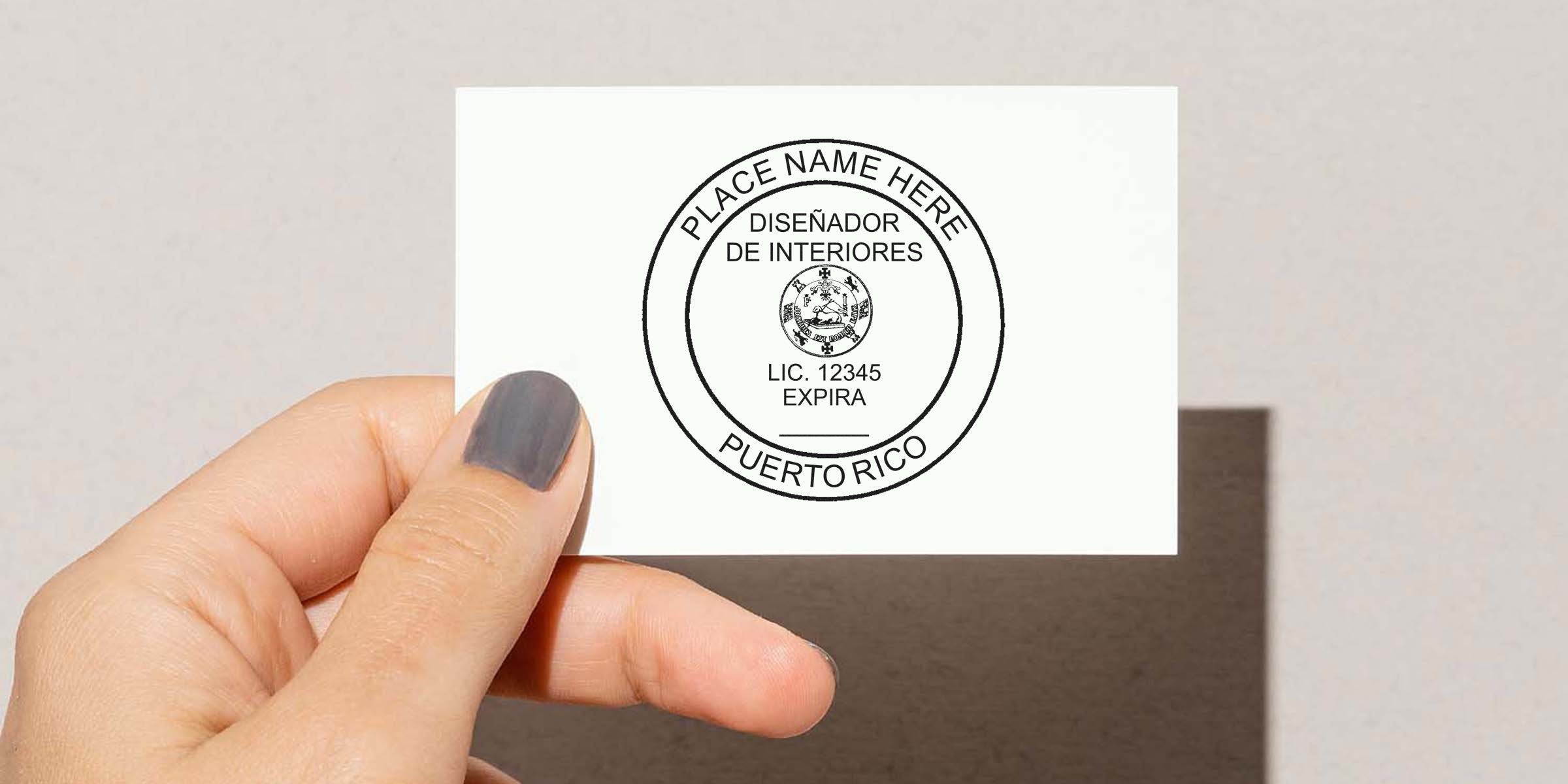 Hand holding Puerto Rico Interior Designer license stamp with customizable name and license number, Design Stamp Puerto Rico.