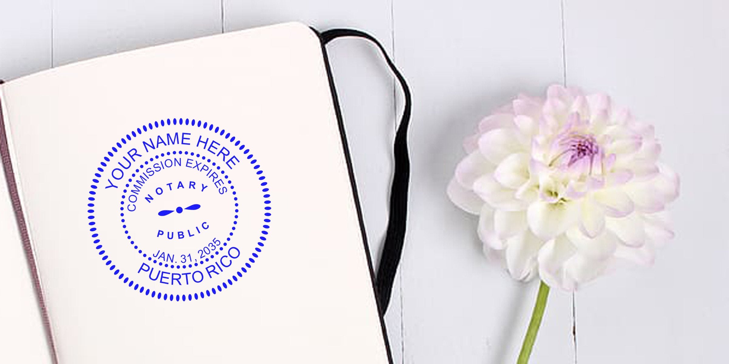 Puerto Rico notary seal on custom stamp next to notebook and white flower on wooden table, perfect for first-time buyer tips.