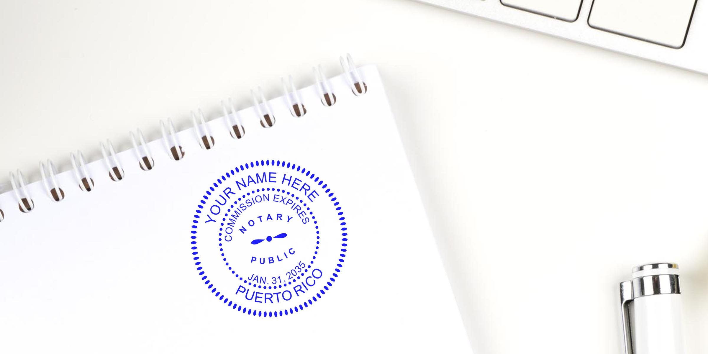 Puerto Rico notary seal stamped on white spiral notebook beside pen and keyboard, illustrating notary public rules.