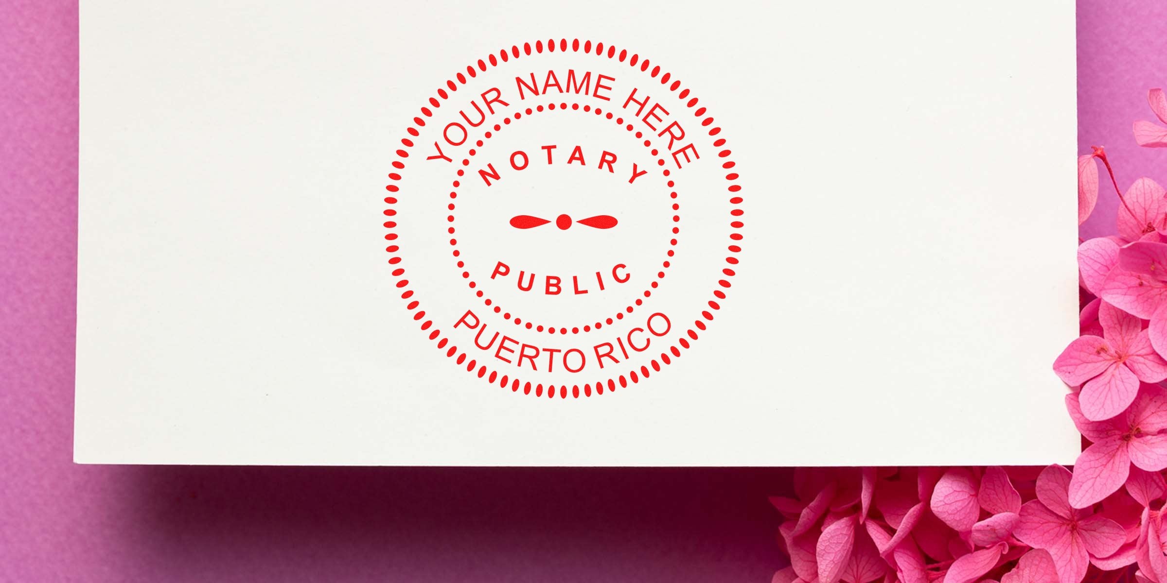 Custom Puerto Rico notary public stamp on white paper with pink flowers, showcasing essential Puerto Rico notary supplies and tools.