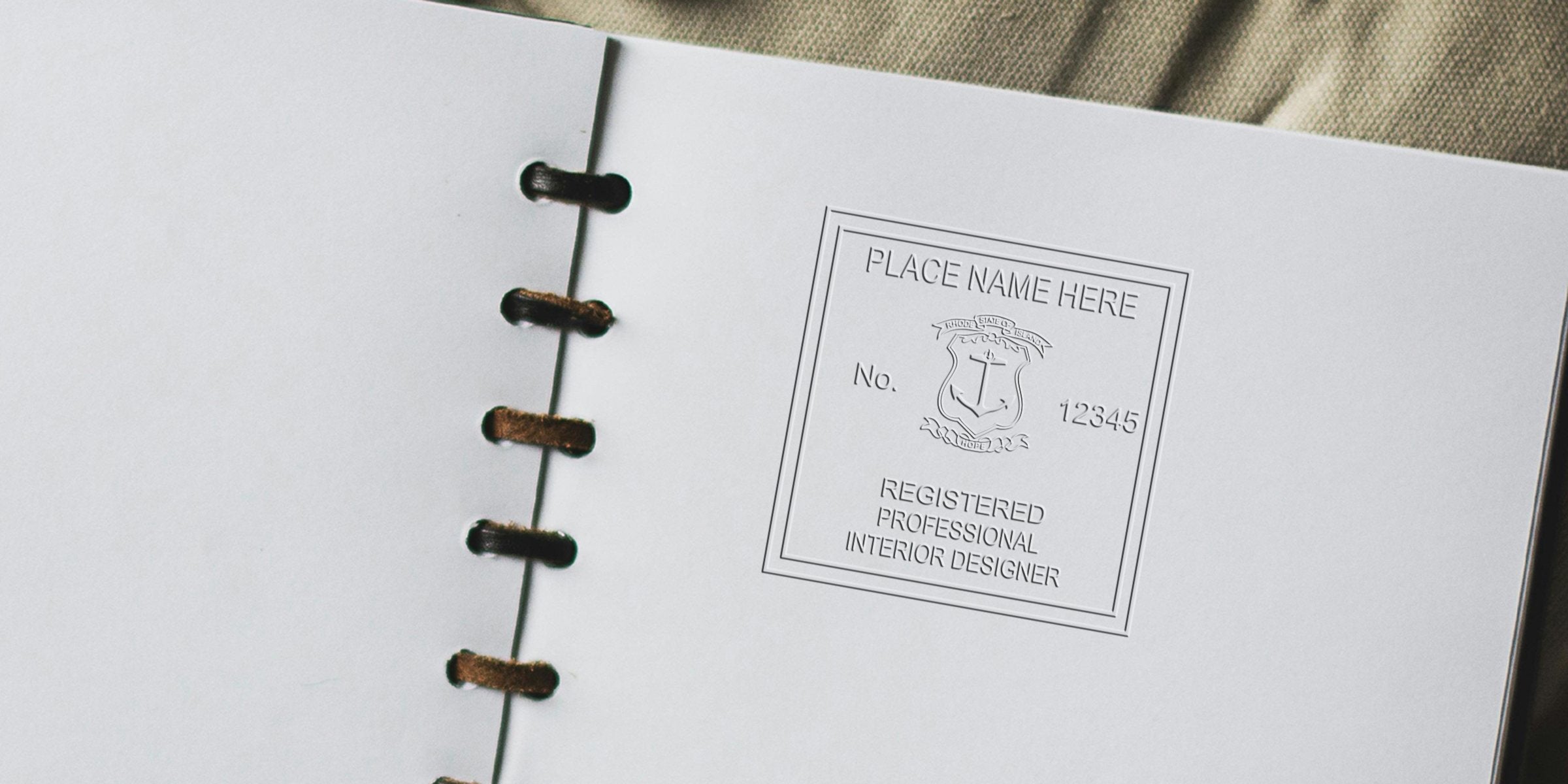 Embossed Rhode Island Interior Designer Certification with seal, meaning, and registration number, shown in a white binder.