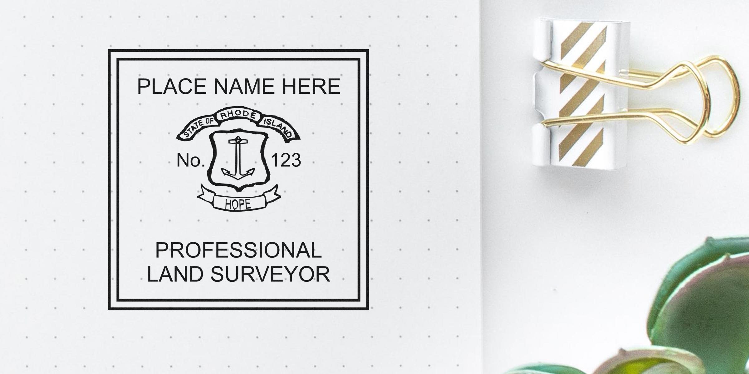 Rhode Island land surveyor stamp with state emblem and gold binder clip on white dotted paper, meeting all land surveyor stamp requirements.
