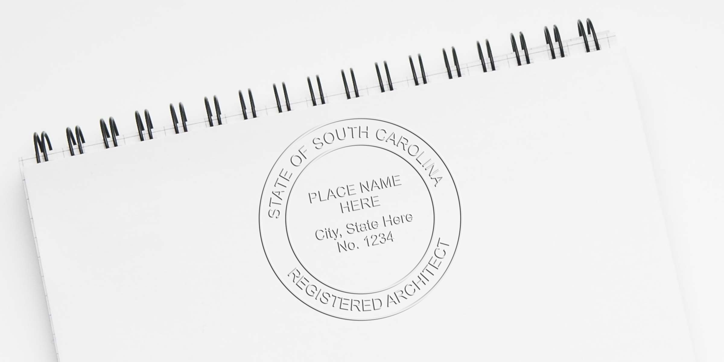 South Carolina architect stamp on white spiral notebook, showing certification stamp rules.