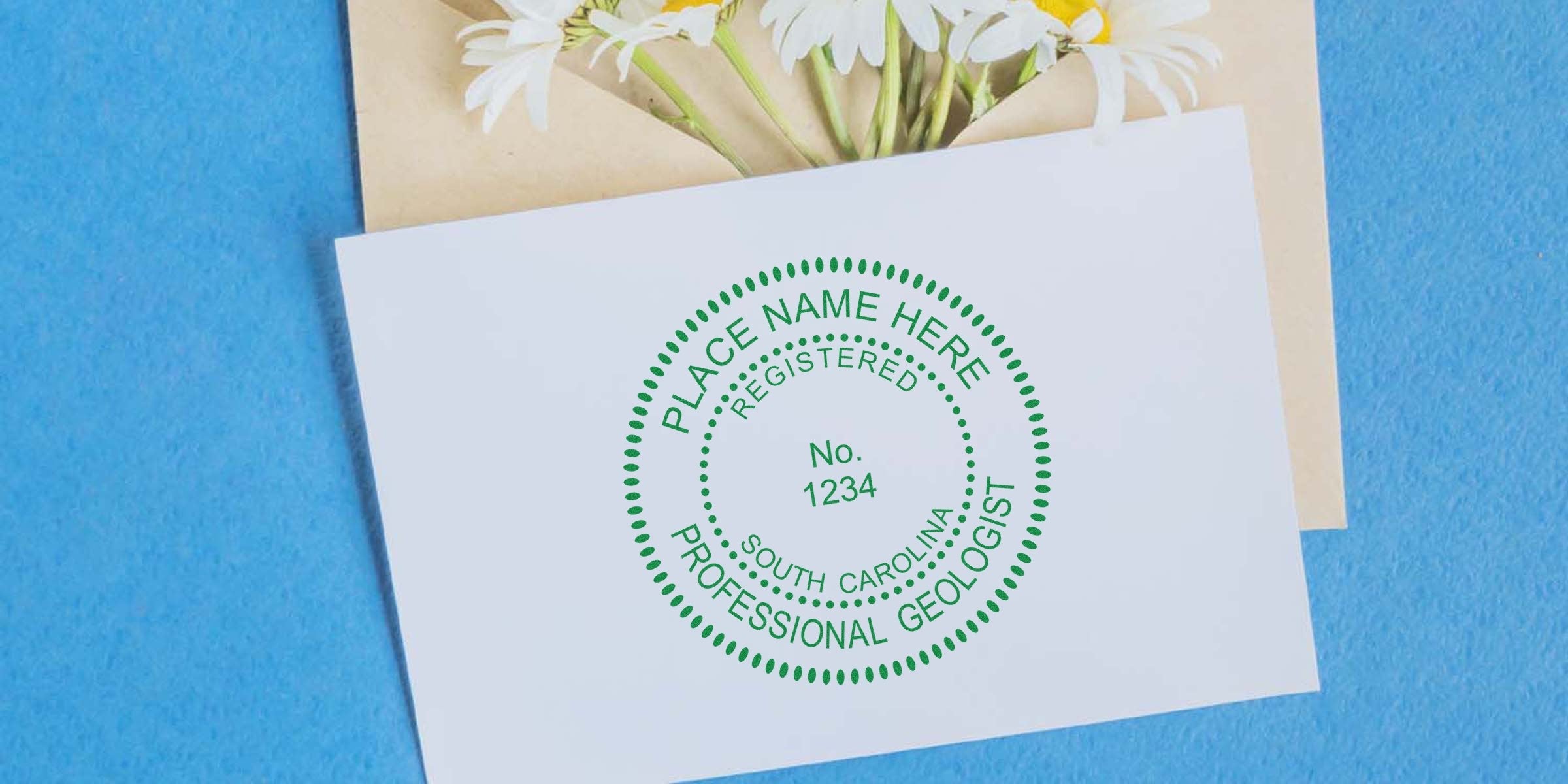 South Carolina geologist stamp embossed on white card with daisies, blue background, and professional geologist embosser tool.
