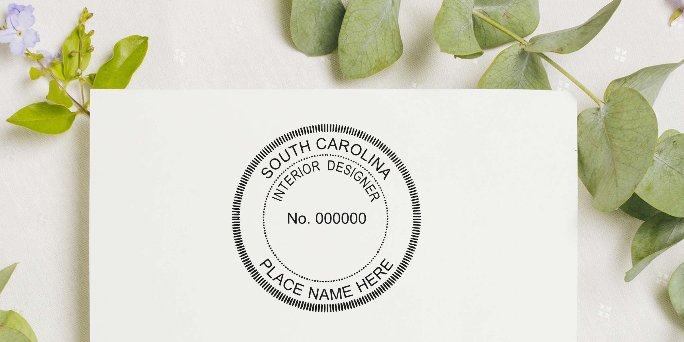 South Carolina interior designer license stamp on white paper with green leaves background, fulfilling interior design stamp requirements.