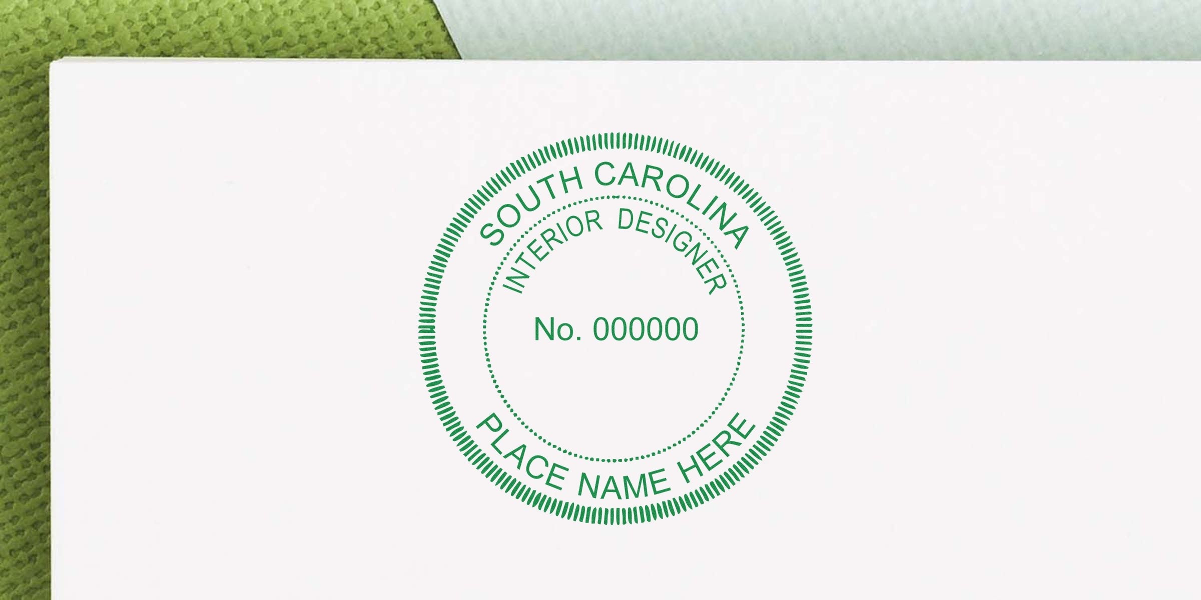 South Carolina interior designer stamp on white paper with green textured background, emphasizing online interior design certification.