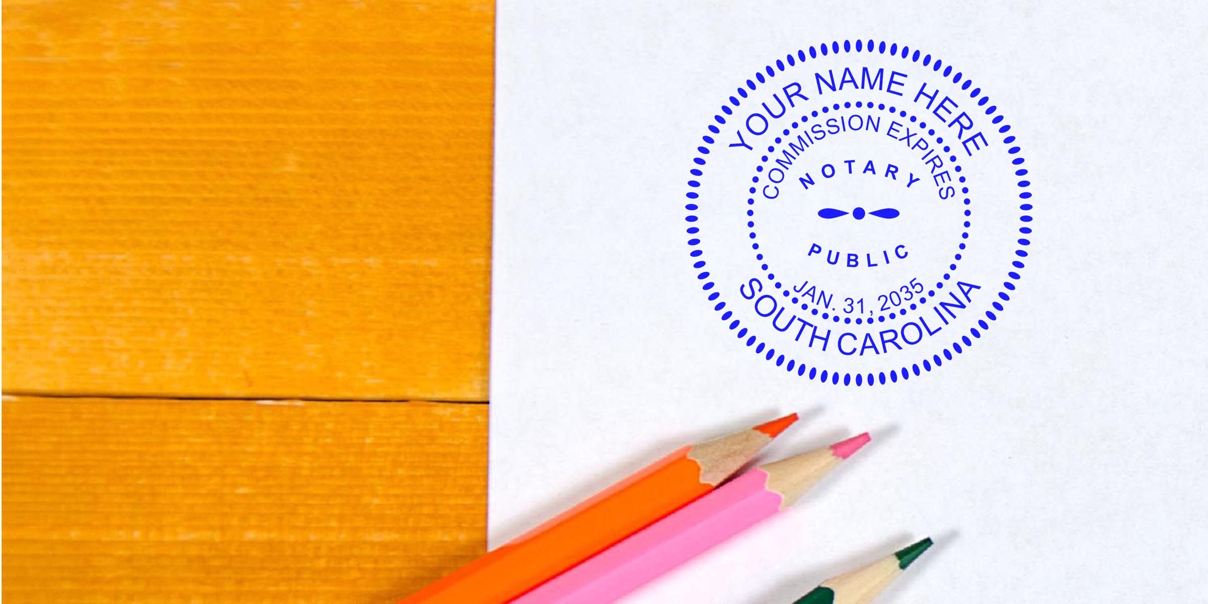 South Carolina notary public stamp on white paper with colored pencils on wooden table, showing South Carolina notary supplies and essentials.