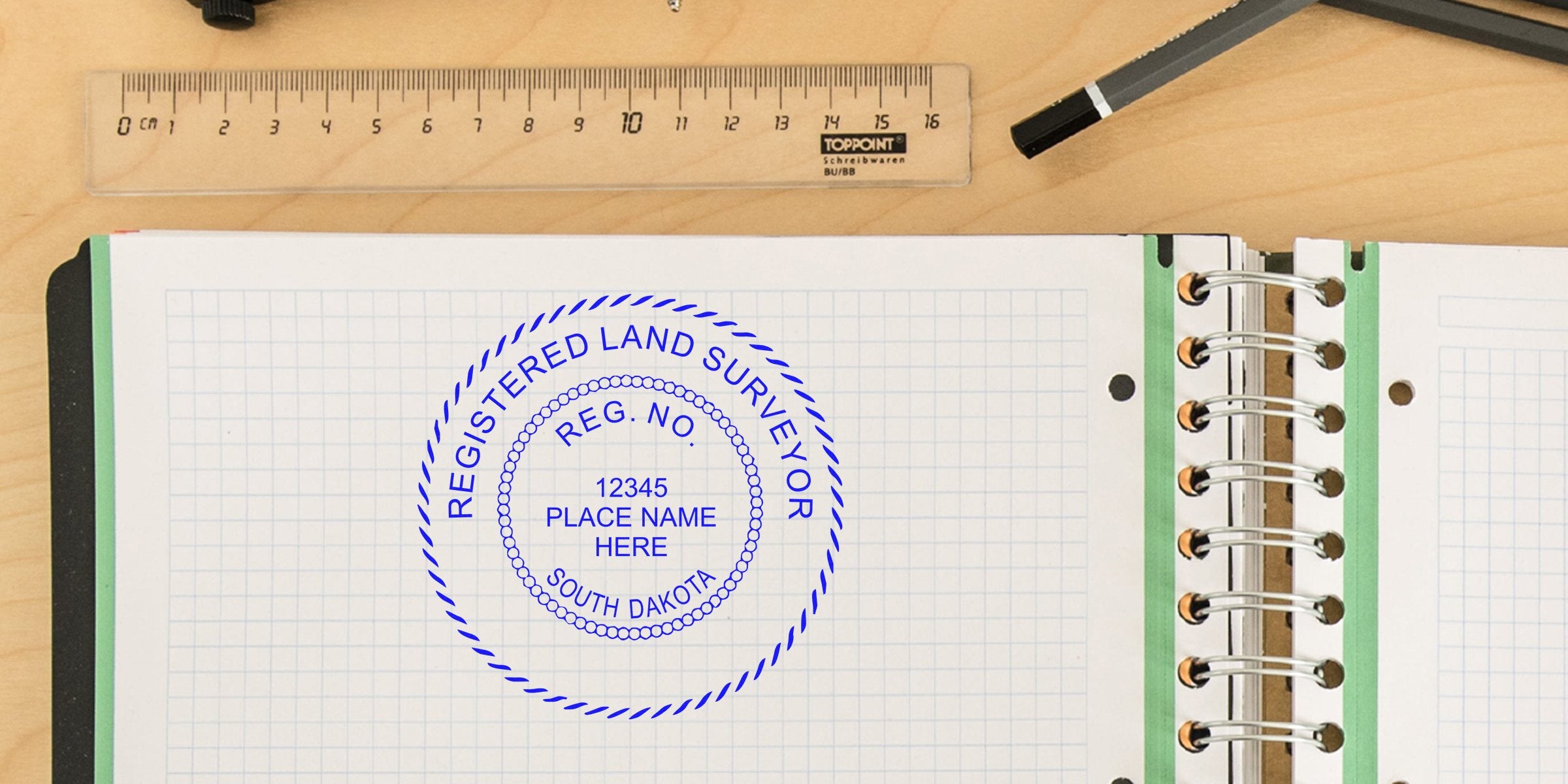 South Dakota land surveyor stamp on graph paper notebook with ruler and pen on wooden desk, emphasizing licensing requirements for land surveying services.