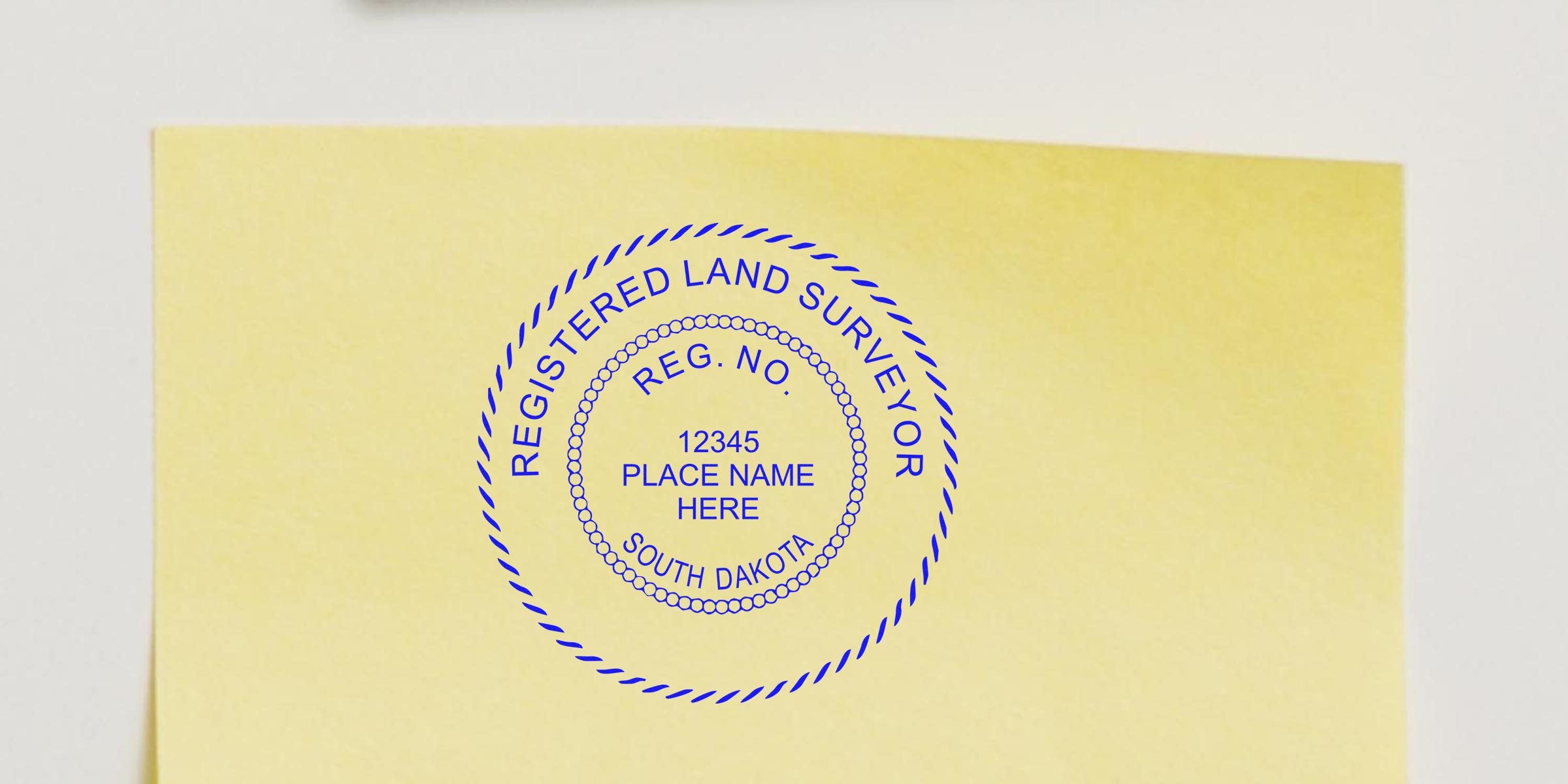 Registered land surveyor stamp on yellow paper with South Dakota stamp template, design, and registration number.