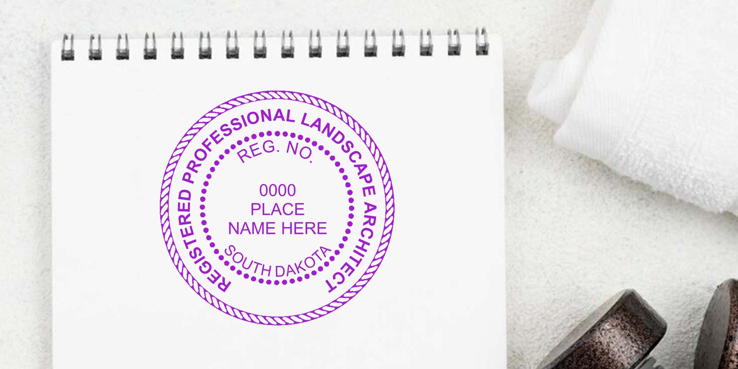 Registered South Dakota landscape architect stamp on white notepad, highlighting registration and common seal errors.