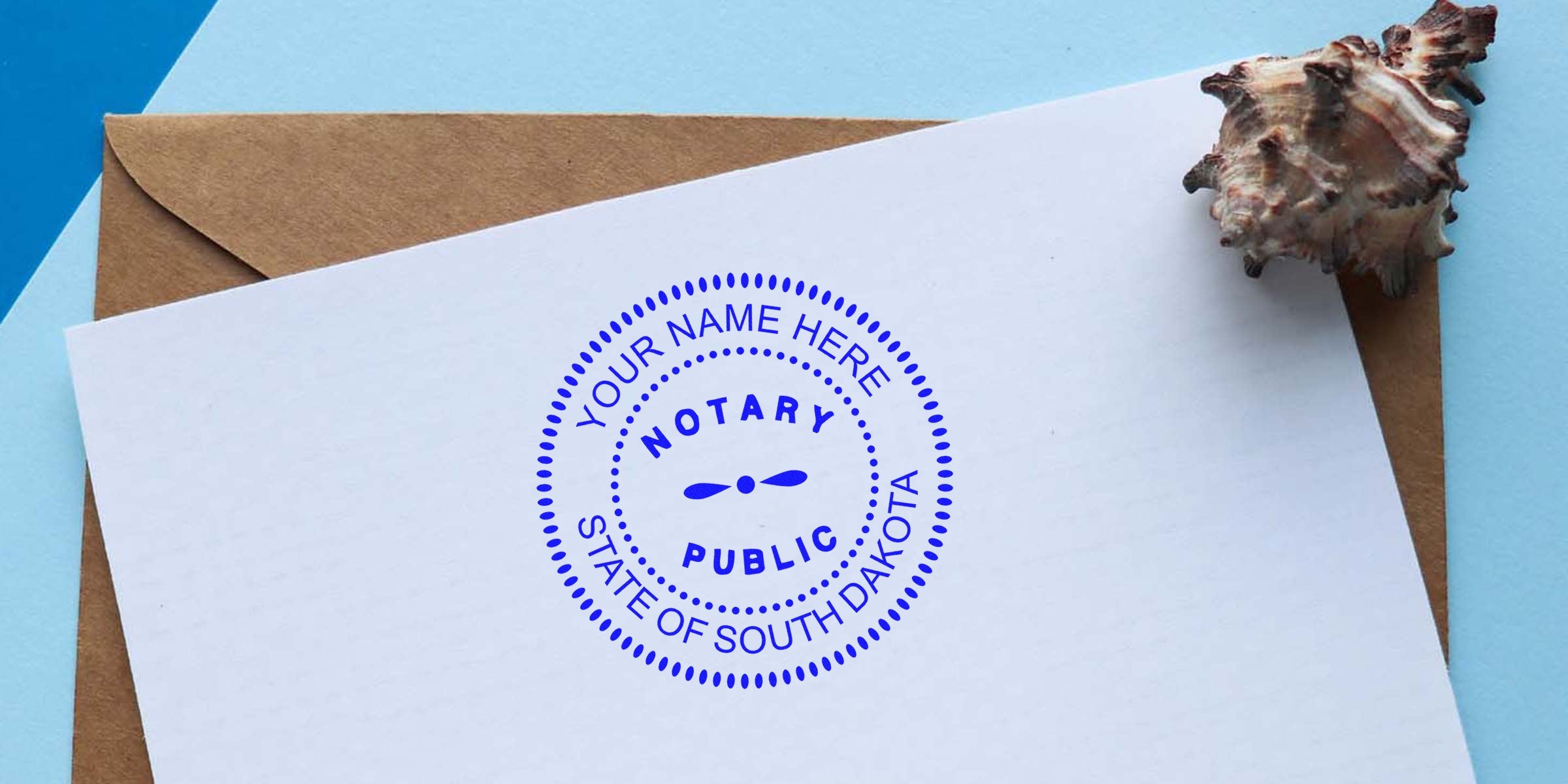 South Dakota notary stamp on white paper with brown envelope and seashell on blue background, showing South Dakota notary stamp and its requirements.