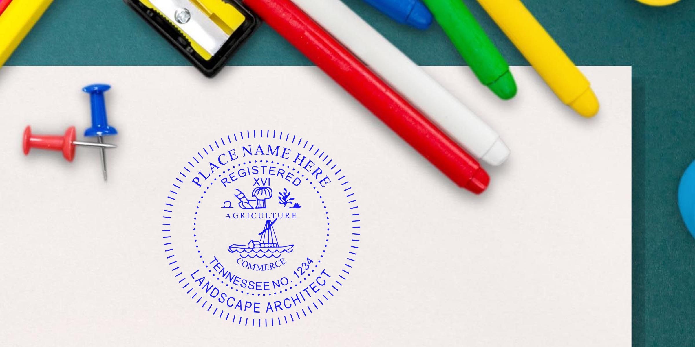 Custom blue Tennessee landscape architect seal on white paper, surrounded by colorful markers and push pins, emphasizing landscape architect licensing requirements.