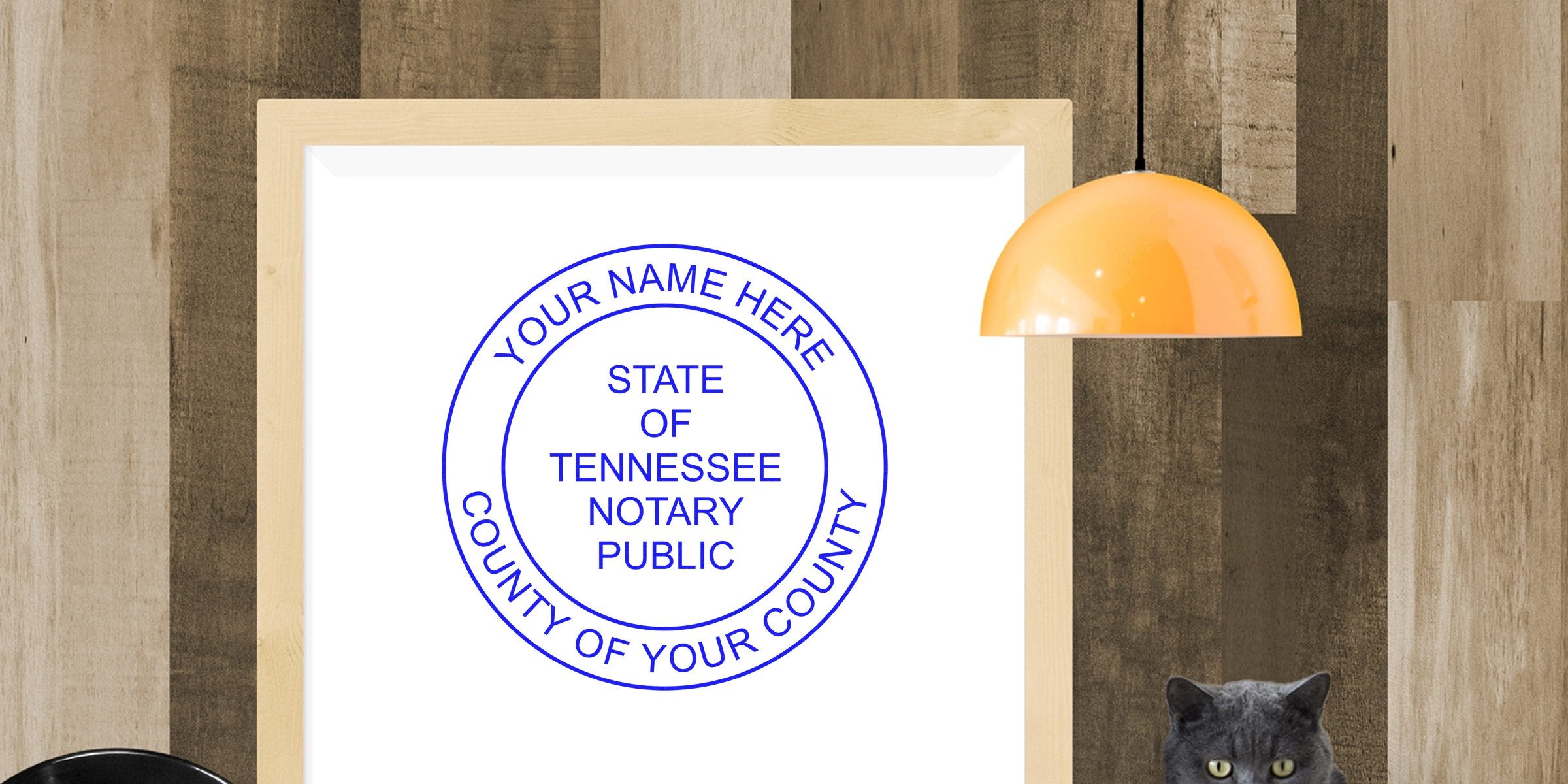 Tennessee notary public stamp with customizable name and county on wood, alongside an orange lamp and gray cat, illustrating Choosing Notary Seal and Notary Seal Tennessee.