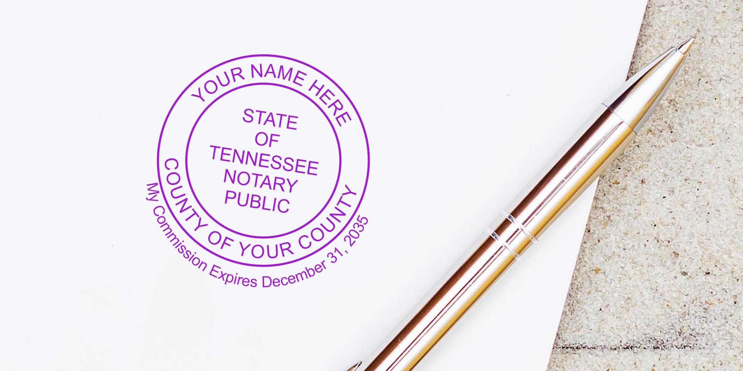 Tennessee notary stamp with silver pen on white paper displaying official notary stamp format for signing documents.