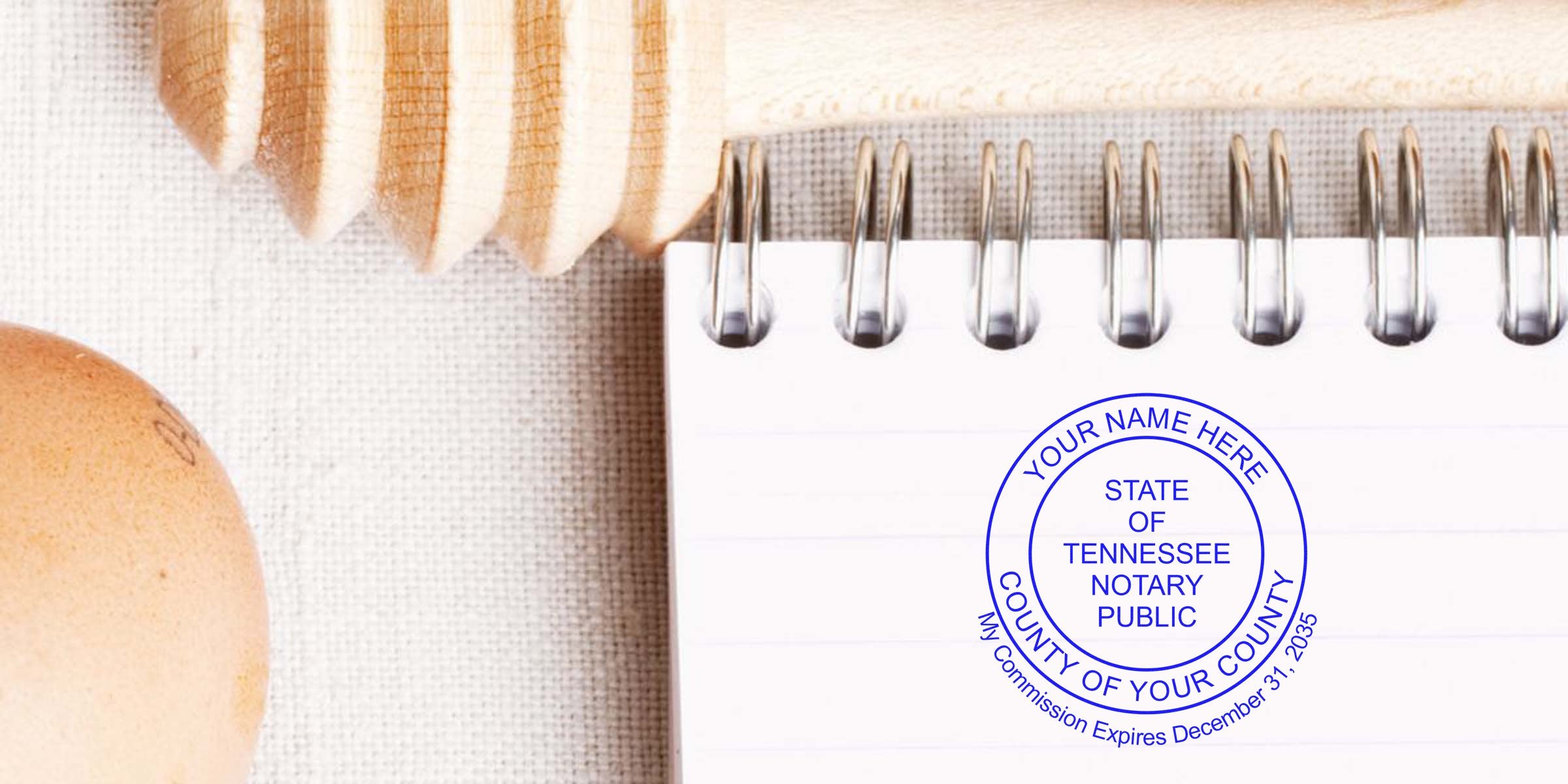 Tennessee Notary Seal stamp on spiral notebook with wooden honey dipper and egg on linen, showcasing Tennessee Notary Benefits.