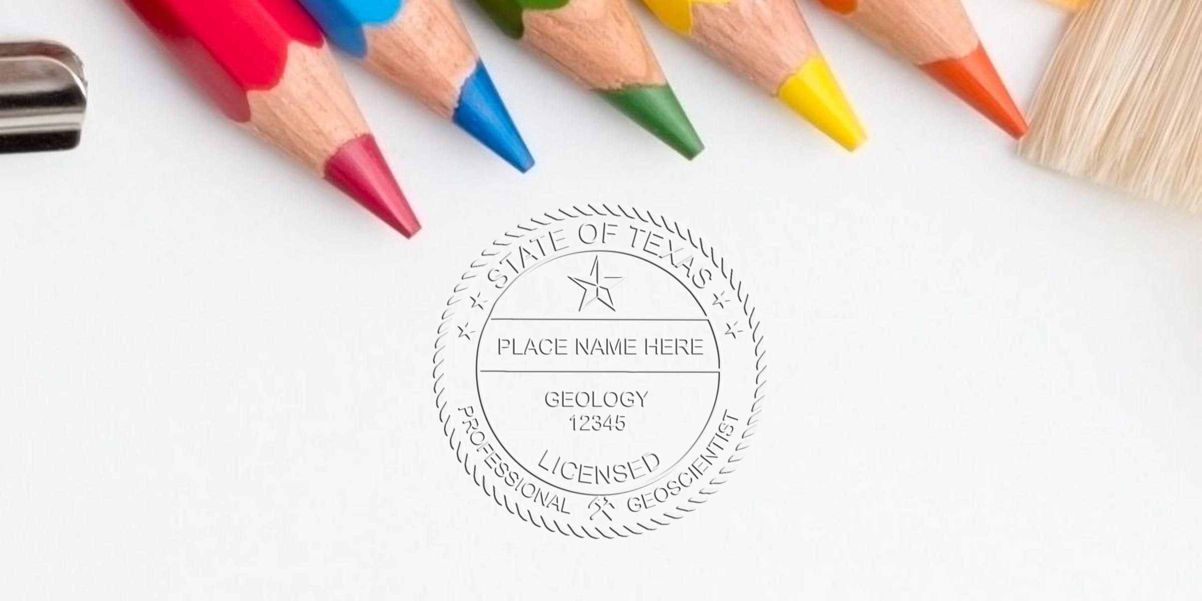 Colored pencils and paintbrush next to Texas licensed professional geoscientist seal on white paper, related to Texas Geologist Stamp and License Renewal.