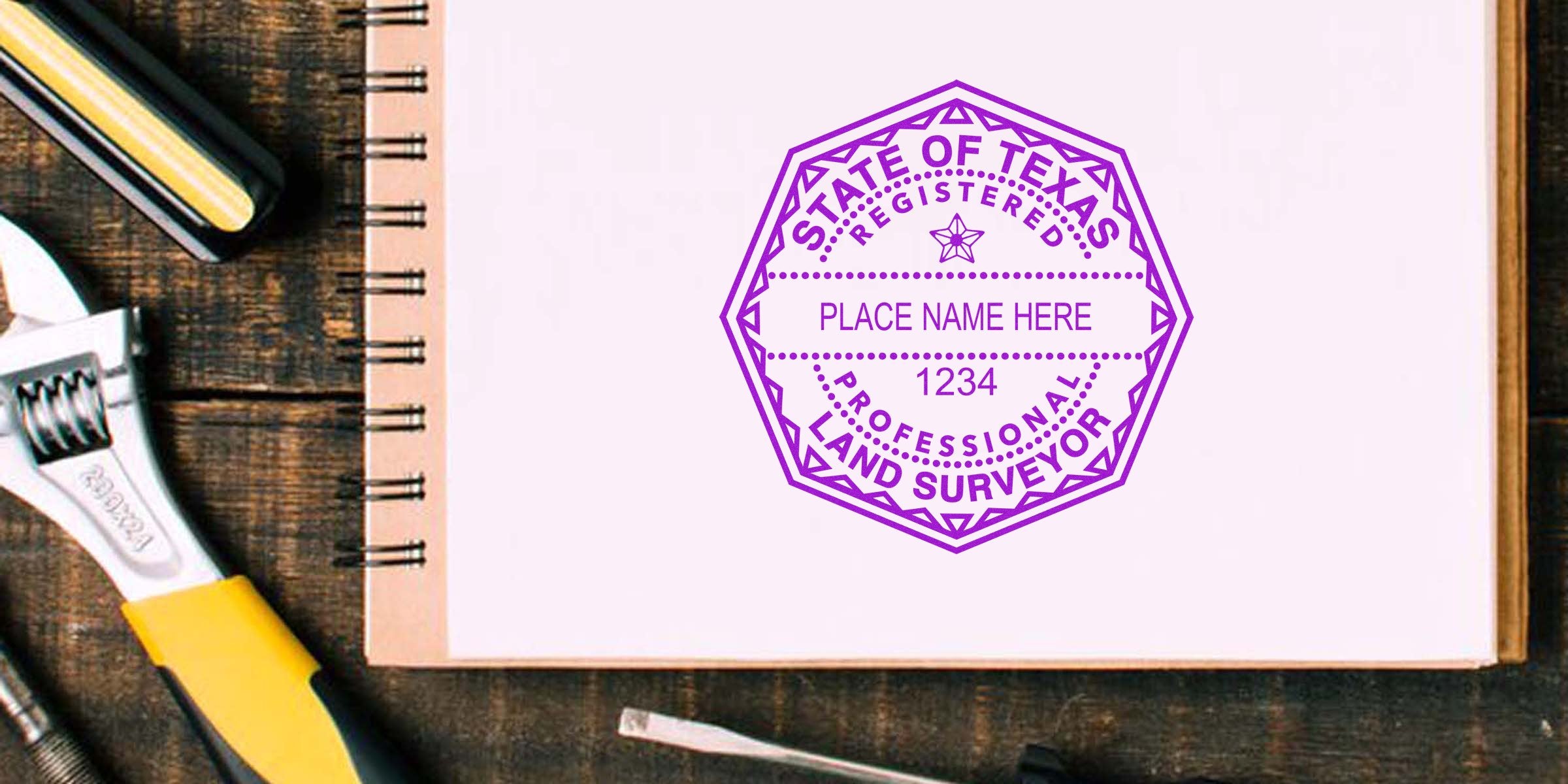 Texas land surveyor stamp on notebook with stamp specs and surveying tools nearby.