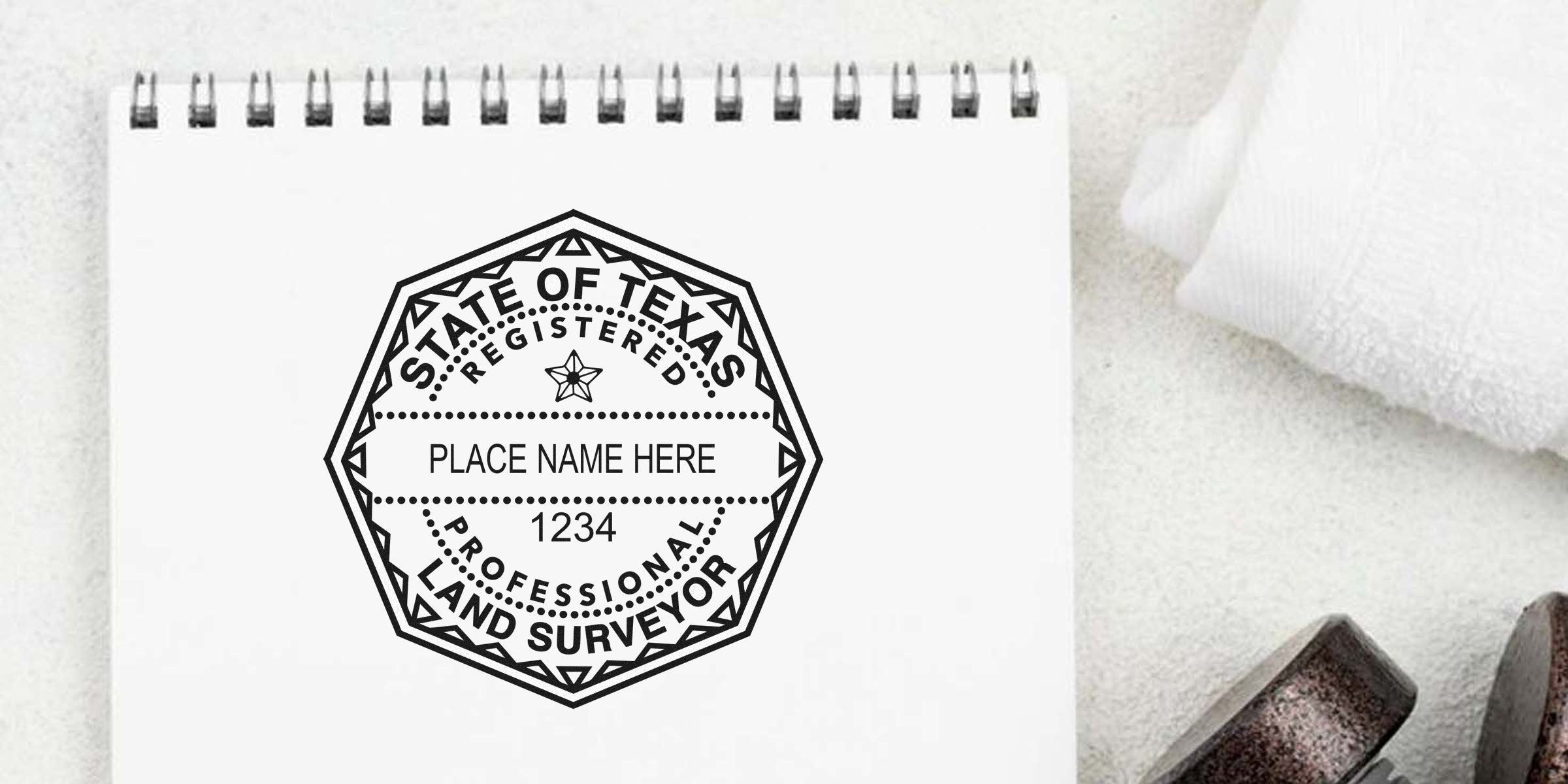Texas land surveyor seal stamp on white notepad showing certification and registration design.