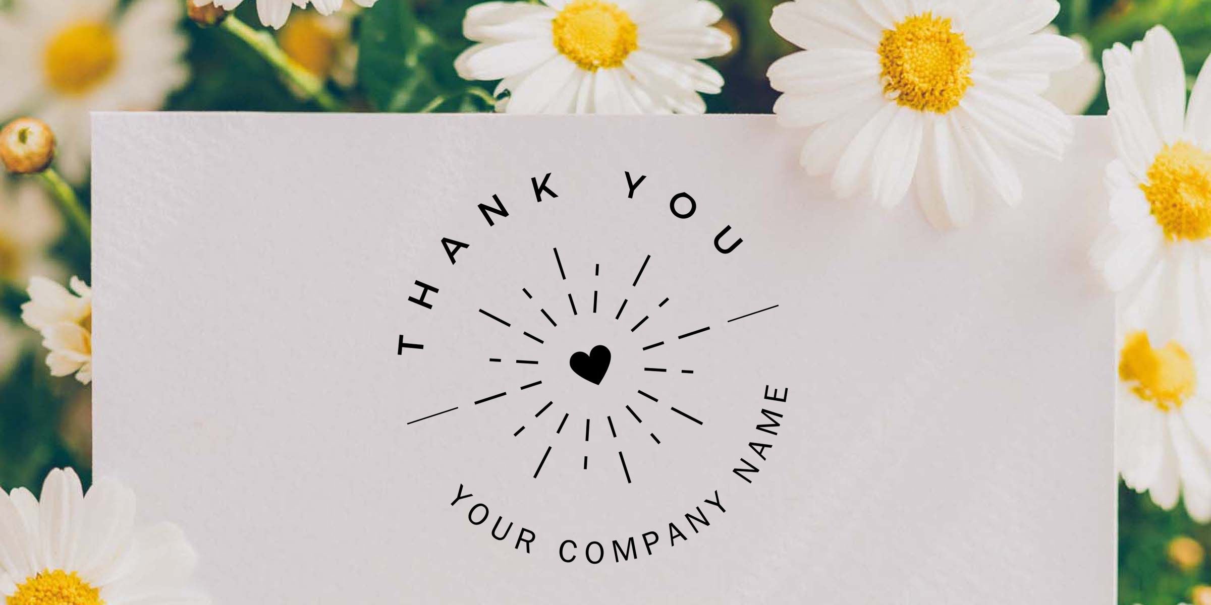 Floral thank you card with black heart logo and customizable company name text, surrounded by white daisies with yellow centers on a soft spring flower background