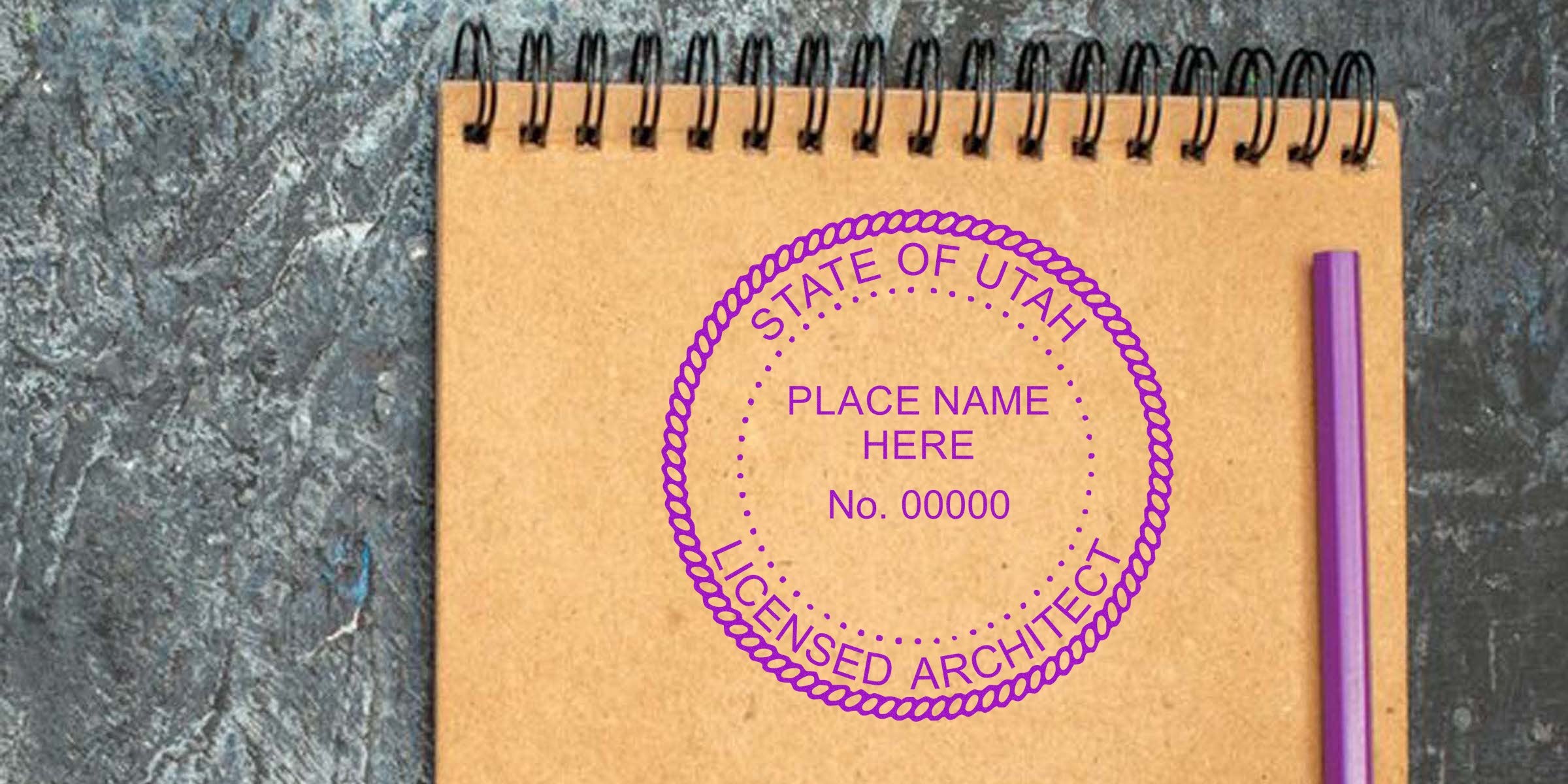 Utah architect stamp on brown notebook with Utah licensed architect seal and purple pen on textured surface.