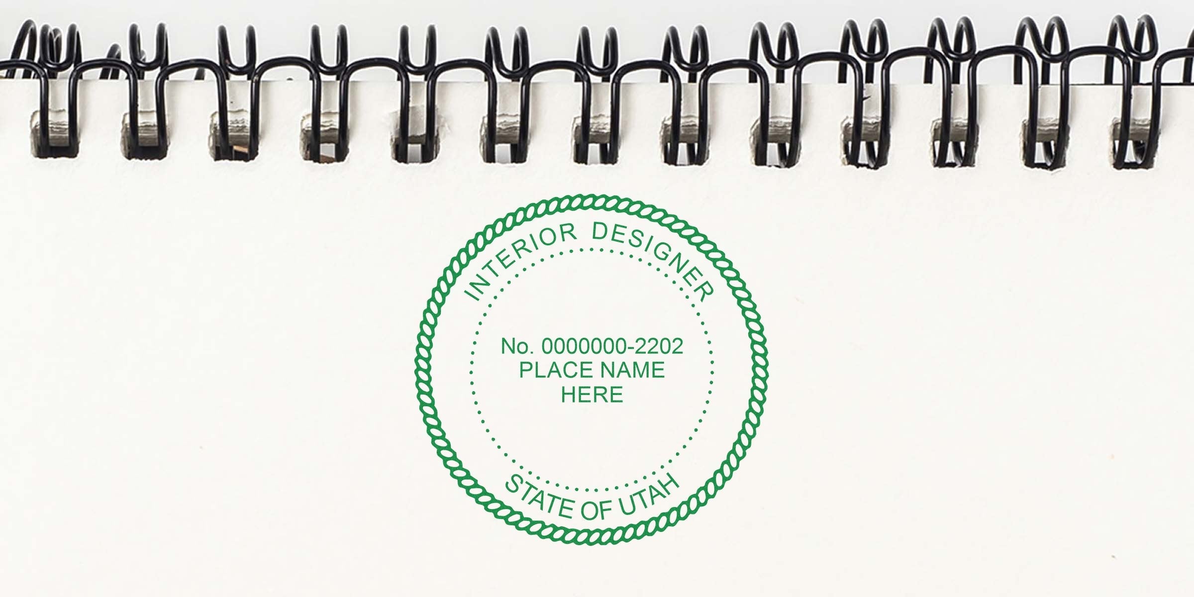 Utah interior designer seal stamped on white spiral notebook page with notes on stamp cost and budgeting interior design fees.