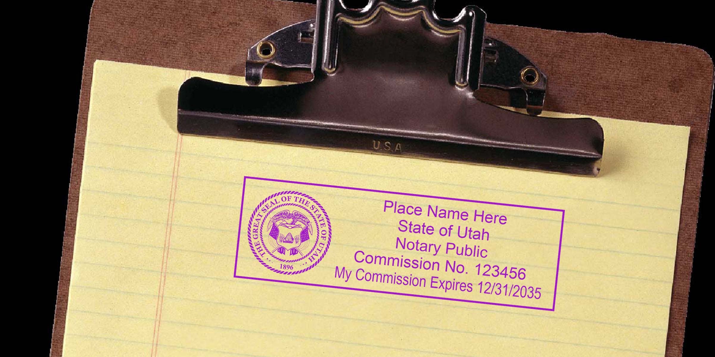 Utah notary public stamp on yellow legal pad with clipboard, showing official stamp use for commission verification.