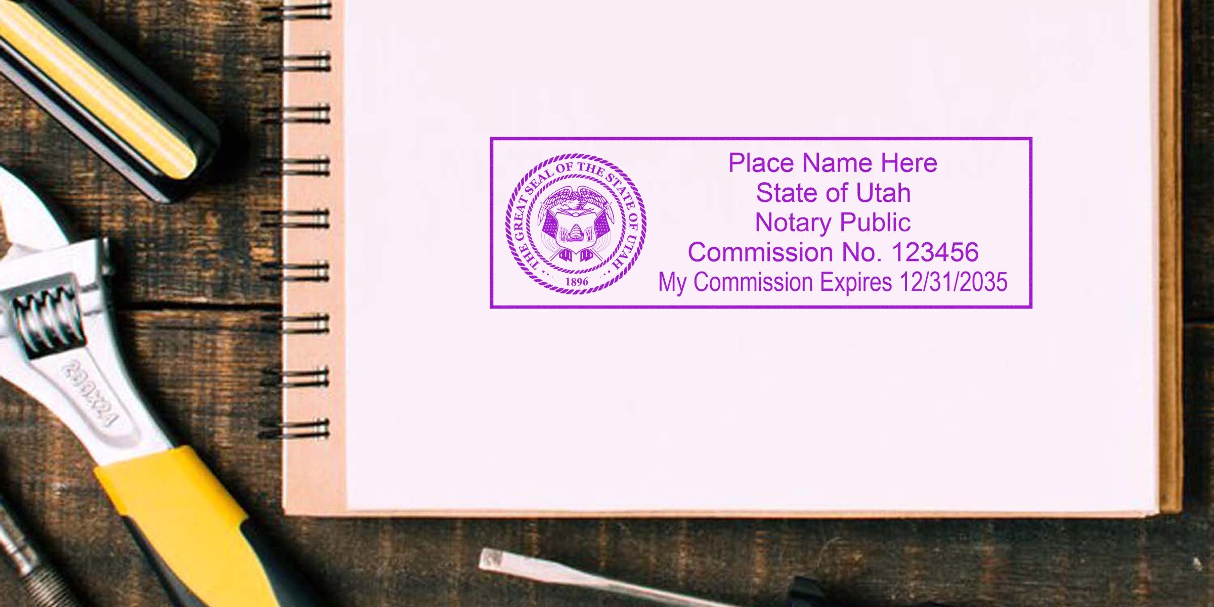 Best Notary Seal Utah stamp on notebook with adjustable wrench and stapler on wooden desk.