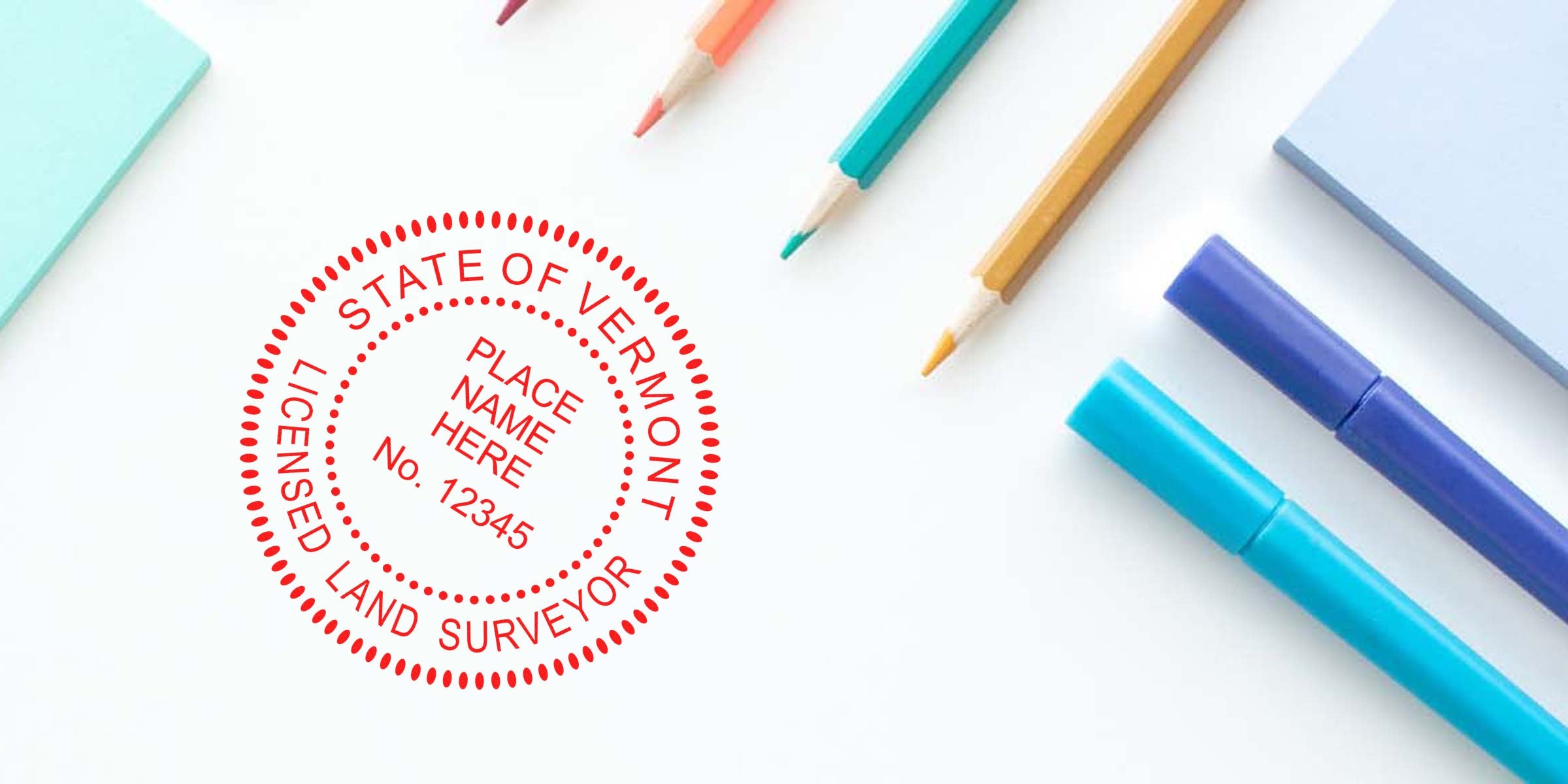 Red Vermont land surveyor seal stamped on white paper, surrounded by colorful pencils and markers, highlighting a professional Vermont land surveyor seal design for surveying services.