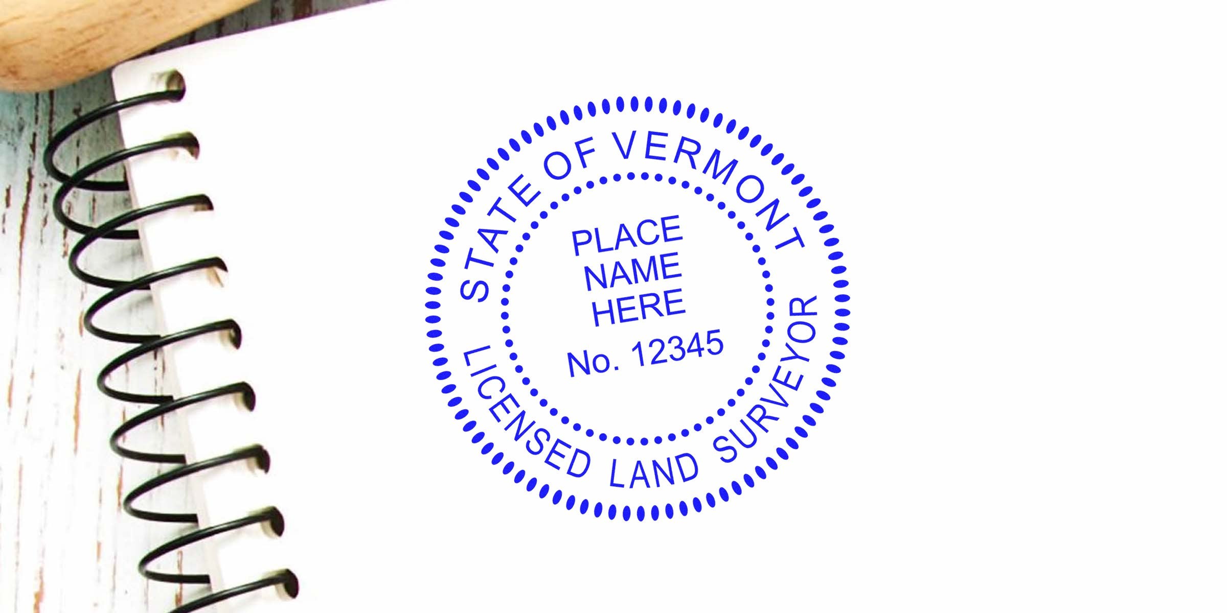 Vermont land surveyor stamp on a white spiral notebook, highlighting custom surveyor stamp essentials.