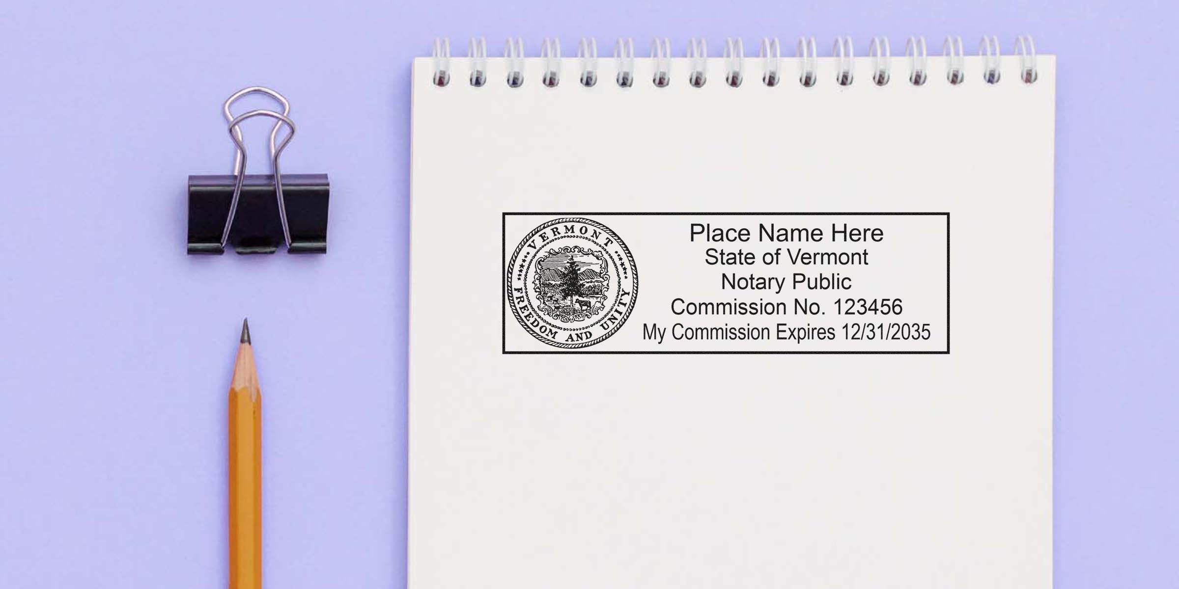 Vermont notary stamp and seal on white notepad with pencil and binder clip, set against a purple background.