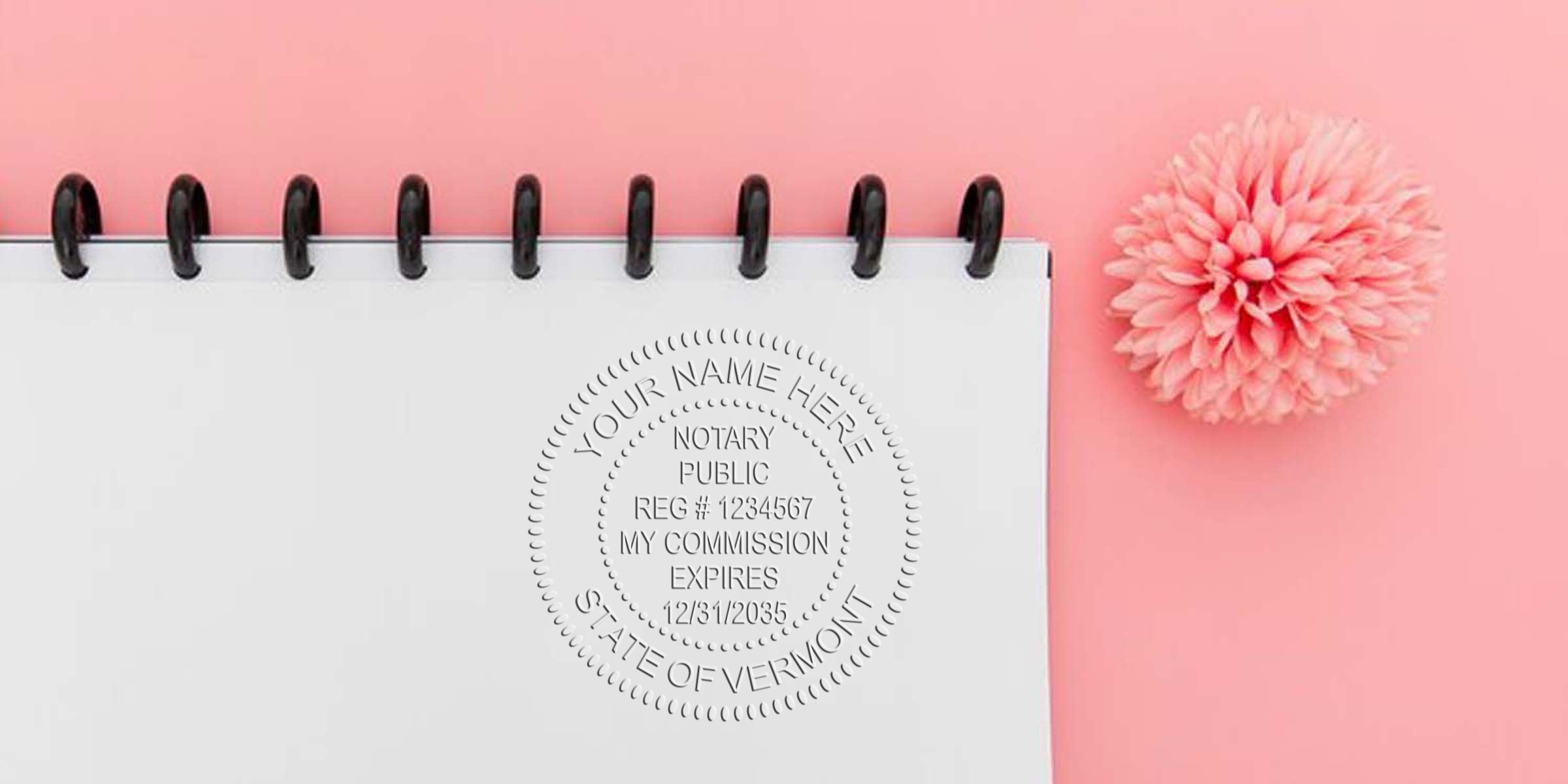 Vermont notary public embossed seal on white notebook with pink flower, displayed on pink background, showing Vermont notary seal size and dimensions.