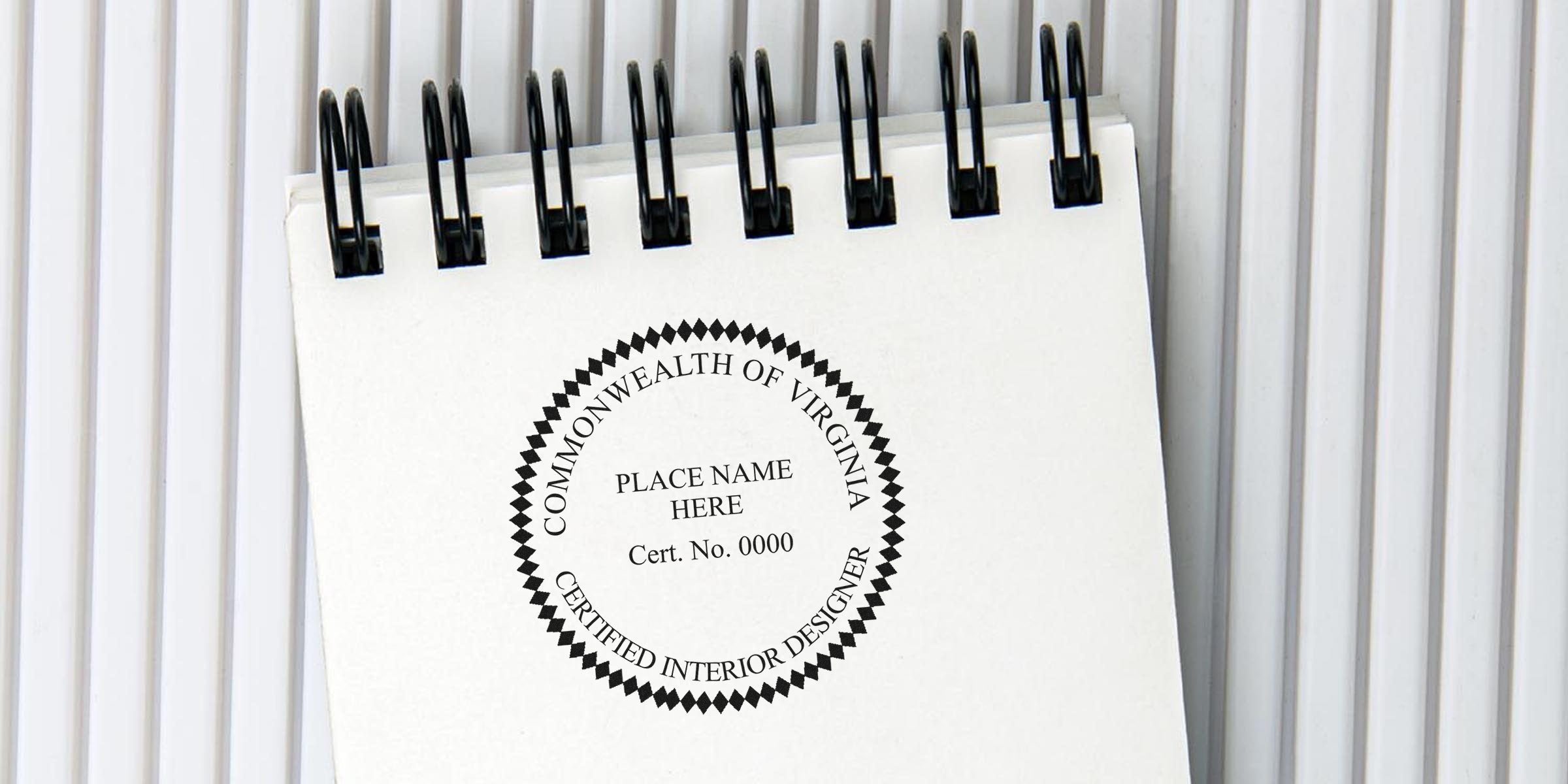 Virginia interior designer renewal stamp on spiral notebook, showing the official seal for professional certification renewal.