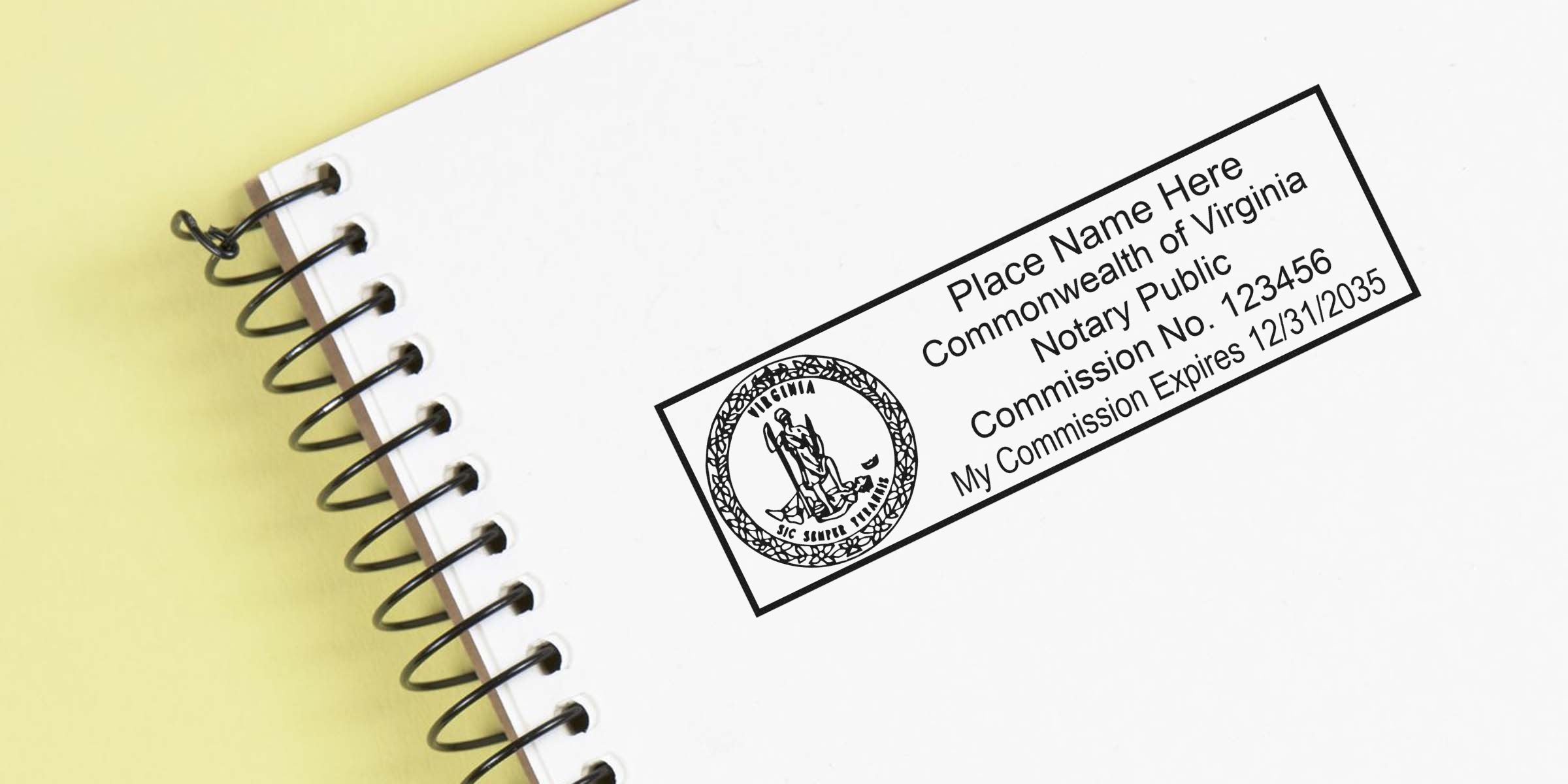 Virginia notary self-inking stamp on a white spiral notebook for official document authentication.