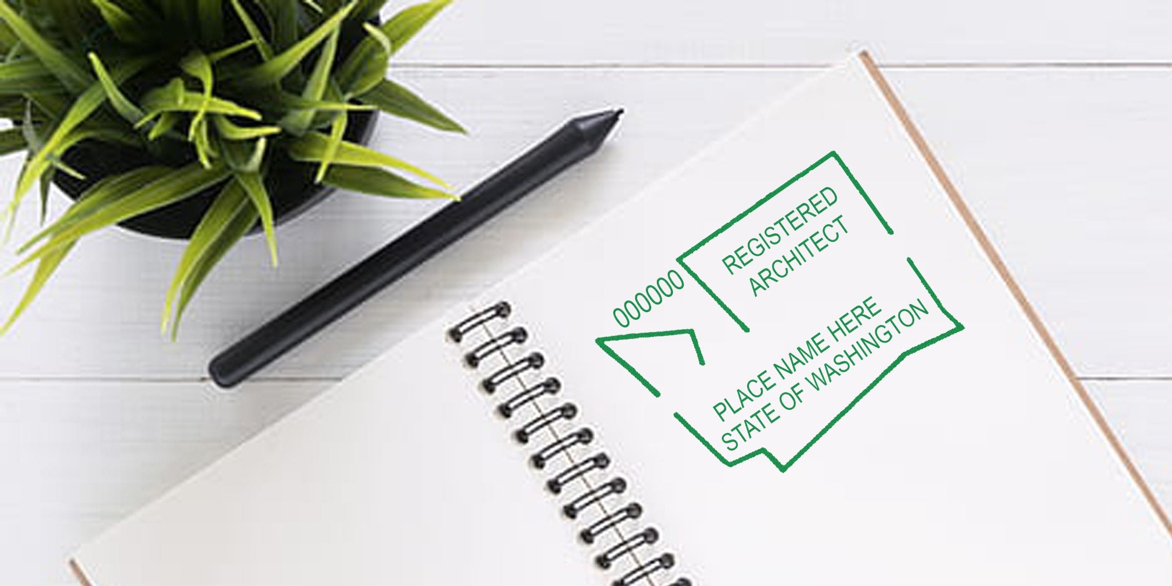 Washington architect seal stamped on notebook with pen and green plant on white wooden desk, showing engraved checklist for architecture license verification.