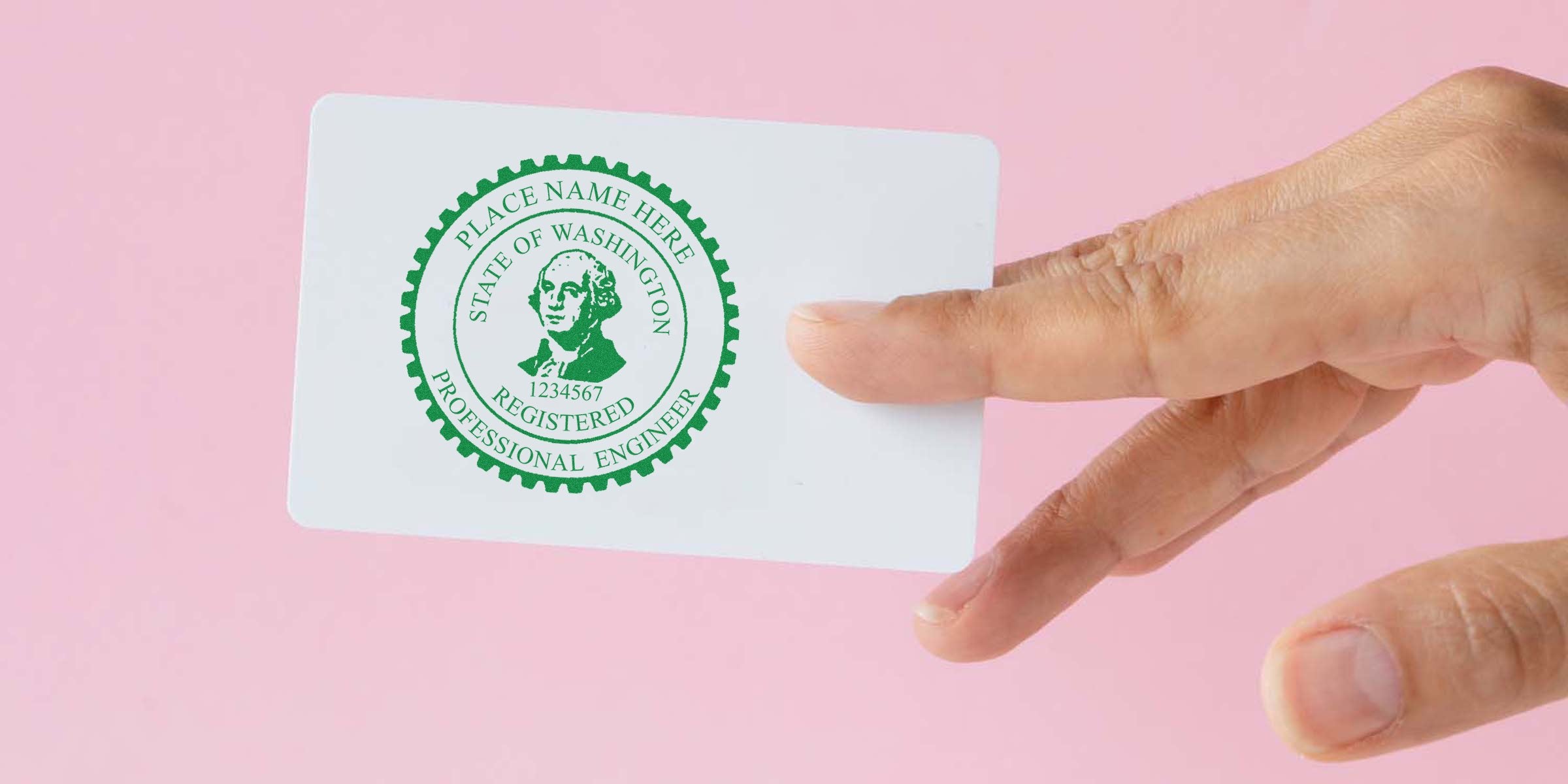 Hand holding Washington professional engineer license card showing Washington Engineer Seal and Certification on a pink background.