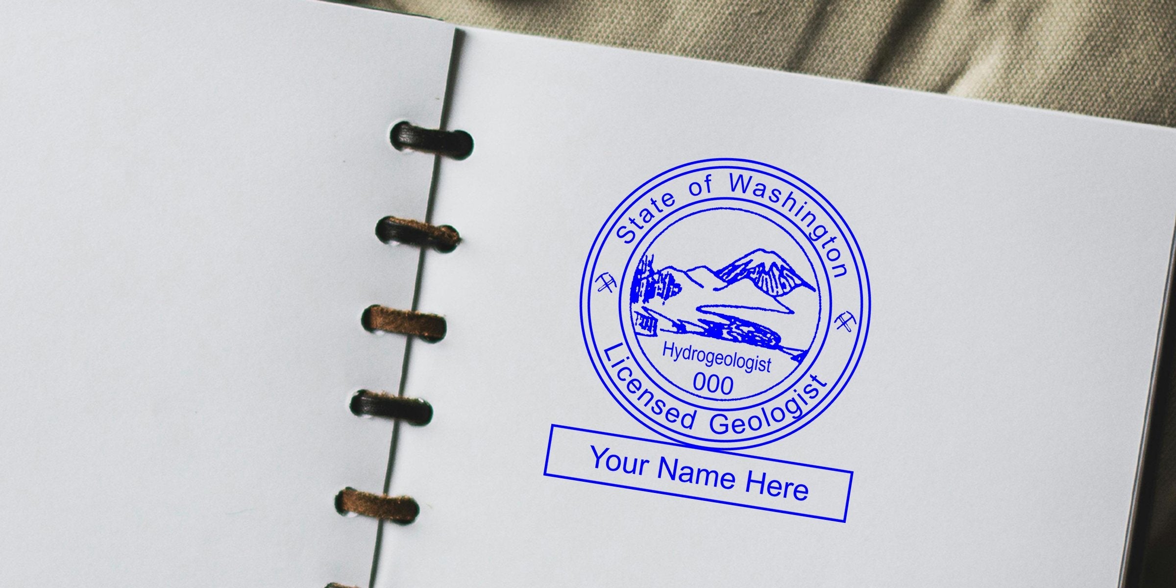 Washington State Geologist Seal stamped on white paper notebook, showcasing the Geologist Seal design for hydrogeologist certification.
