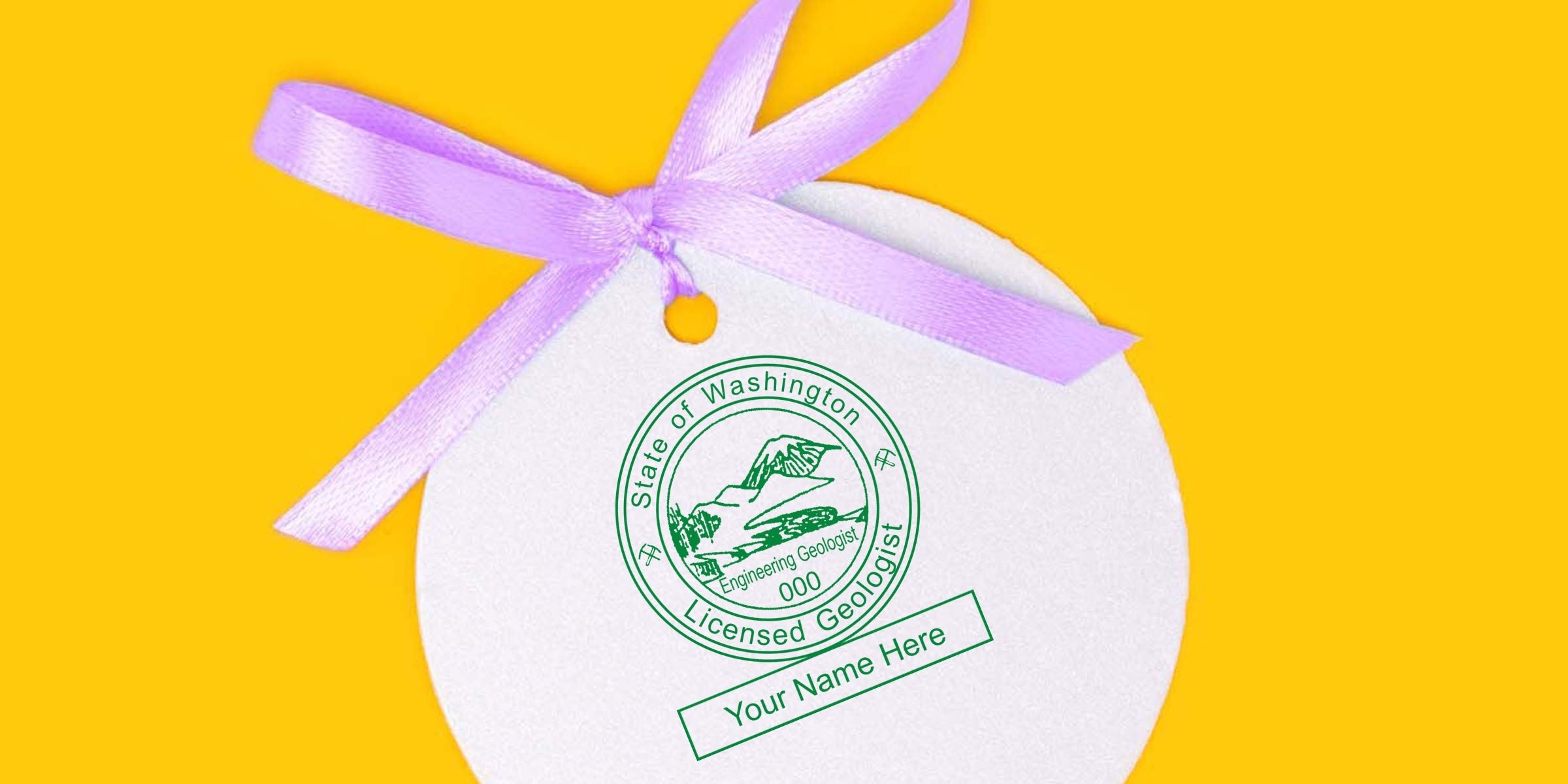 Washington Geologist Stamp with purple ribbon on white tag against yellow background, complying with Geologist Stamp Guidelines.