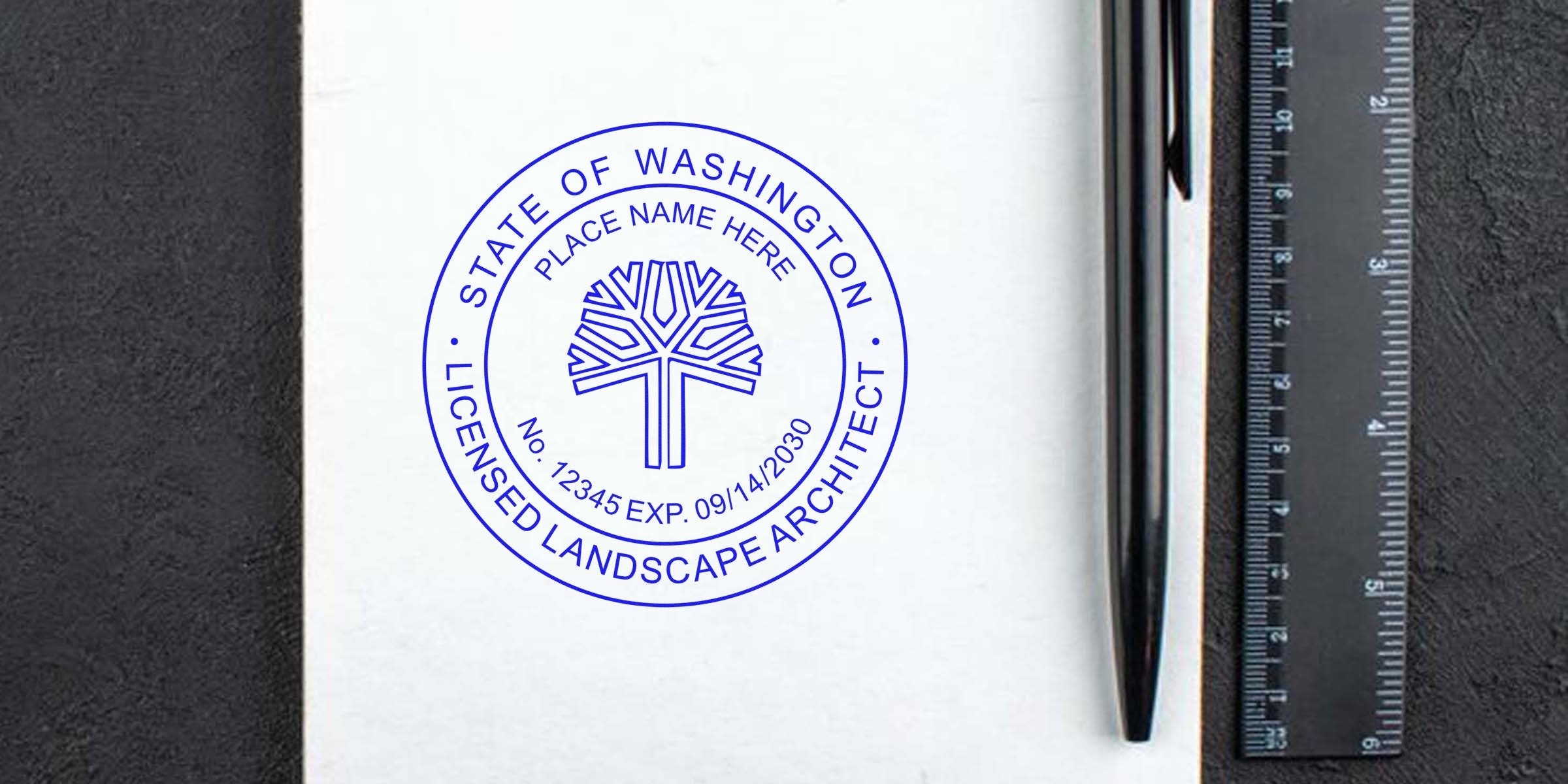 Washington landscape architect seal on white paper with pen and ruler, showing a landscape architect stamp design.