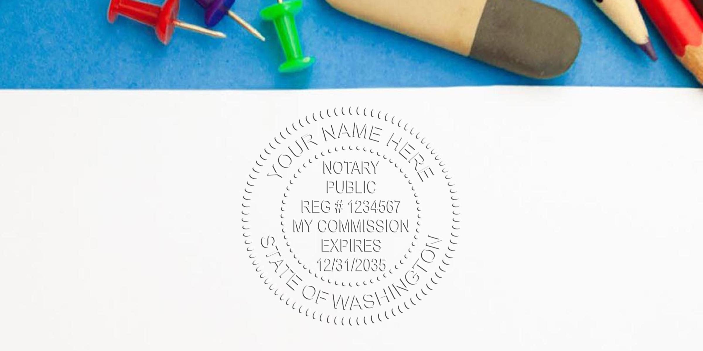 Washington notary stamp on white paper with office supplies, showing state notary commission seal, official registration, and expiration date; purchase notary stamp online.