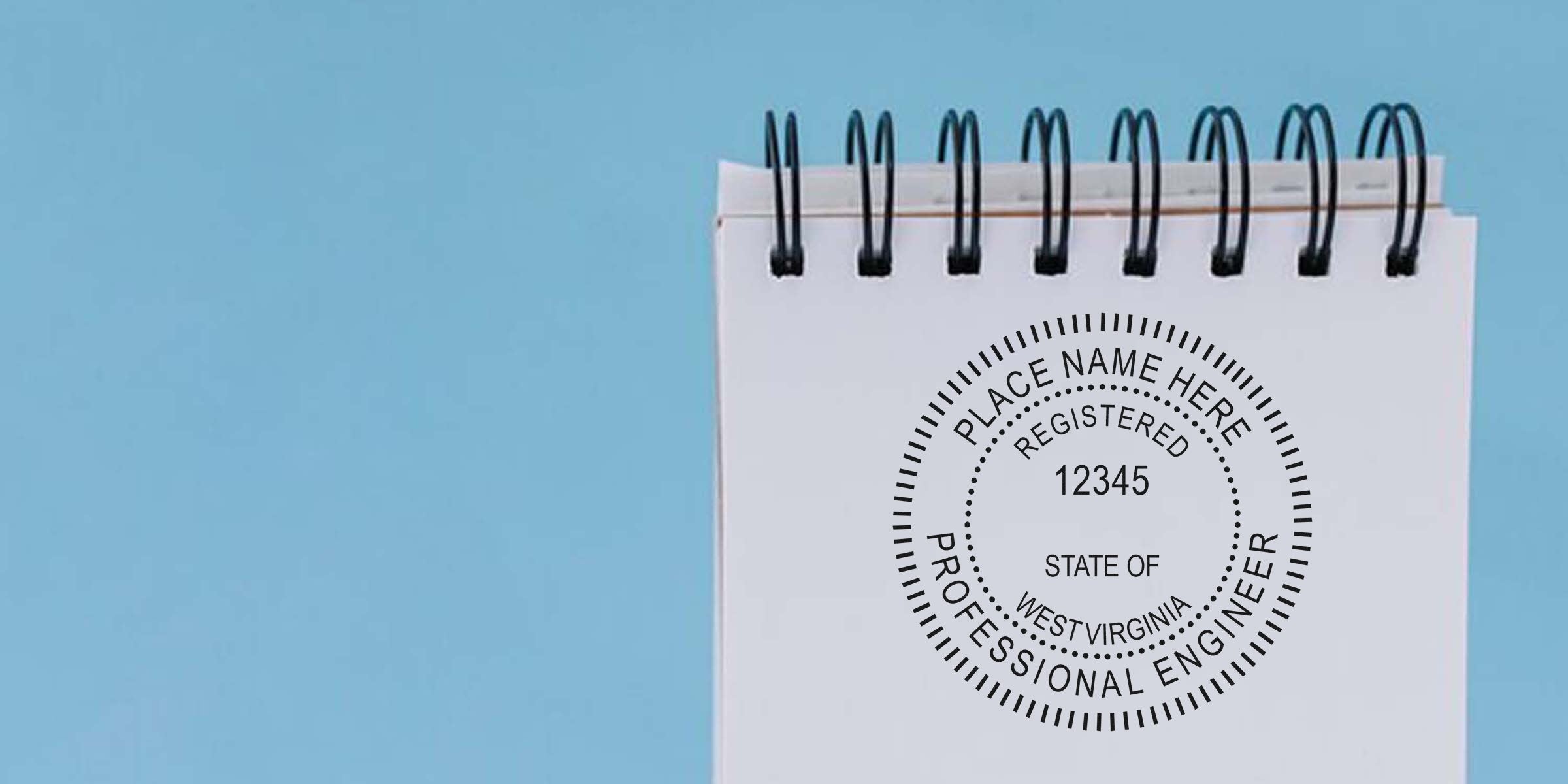 WV professional engineer seal stamped on spiral notebook with blue background, showing registered West Virginia engineering seal.