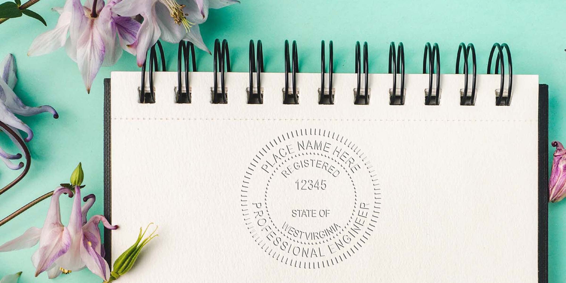 West Virginia Professional Engineer stamp on a spiral notebook with flowers, set against a turquoise background, showcasing the WV Engineering License.